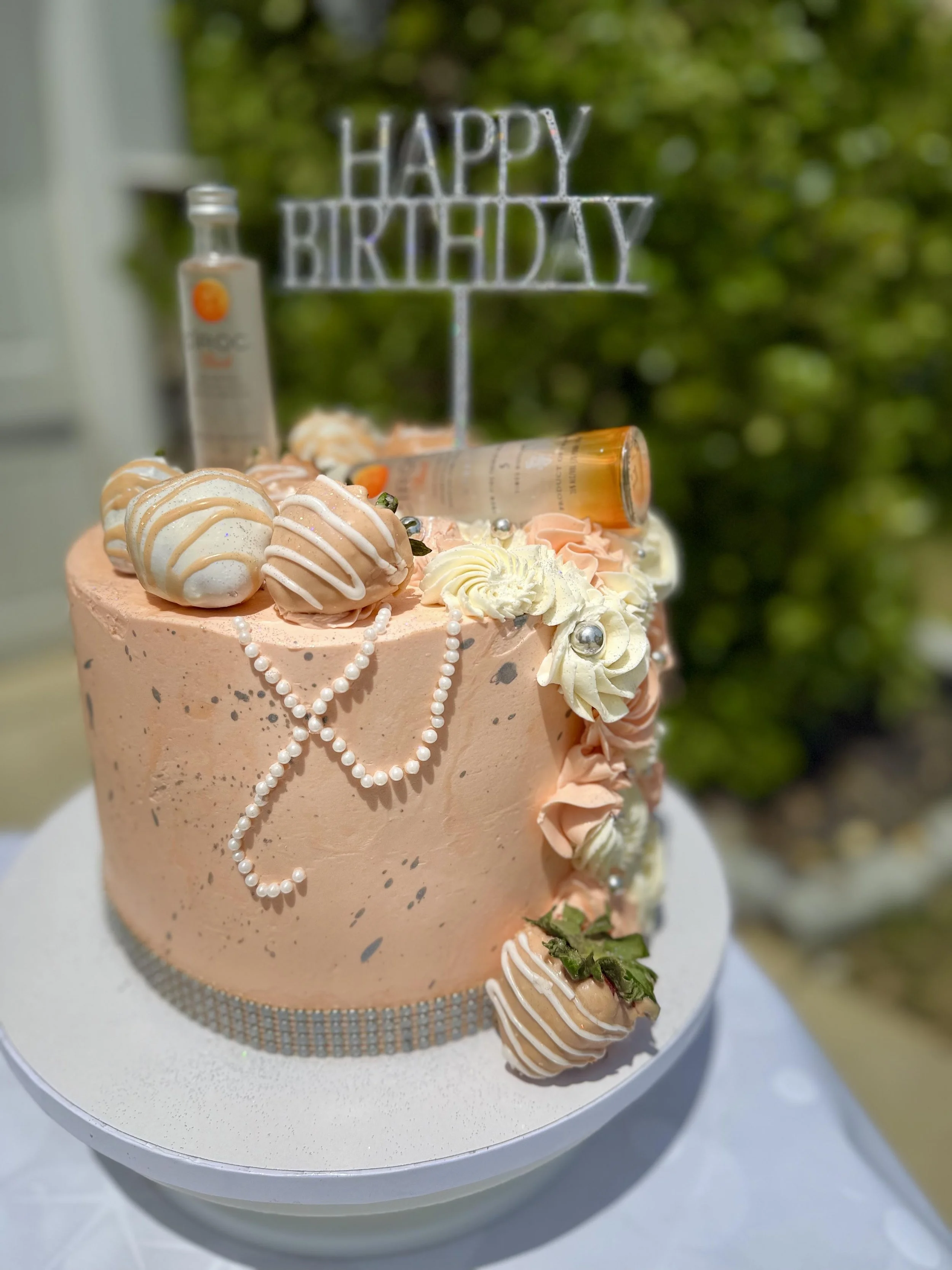 Black owned bakery near me, Vanessa Sencherey, Charlotte NC, organic chocolate dipped strawberries, peach cake, mini ciroc bottle, edible pearls, cake alcohol theme