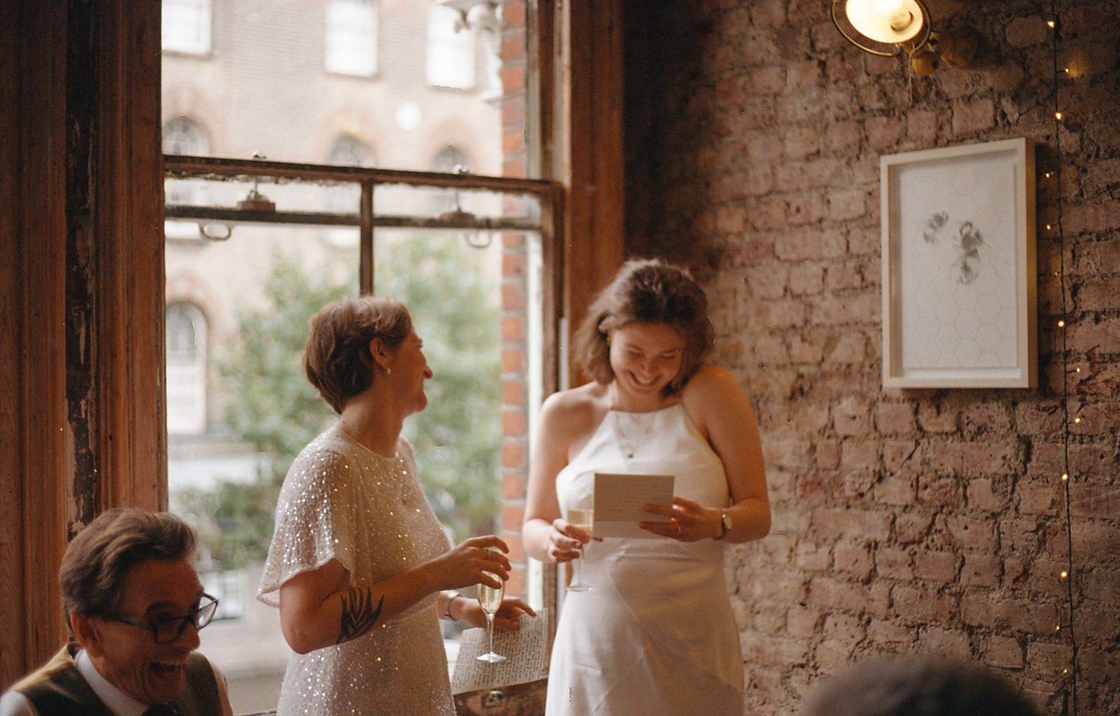 Queer couple reading speeches at their wedding in London