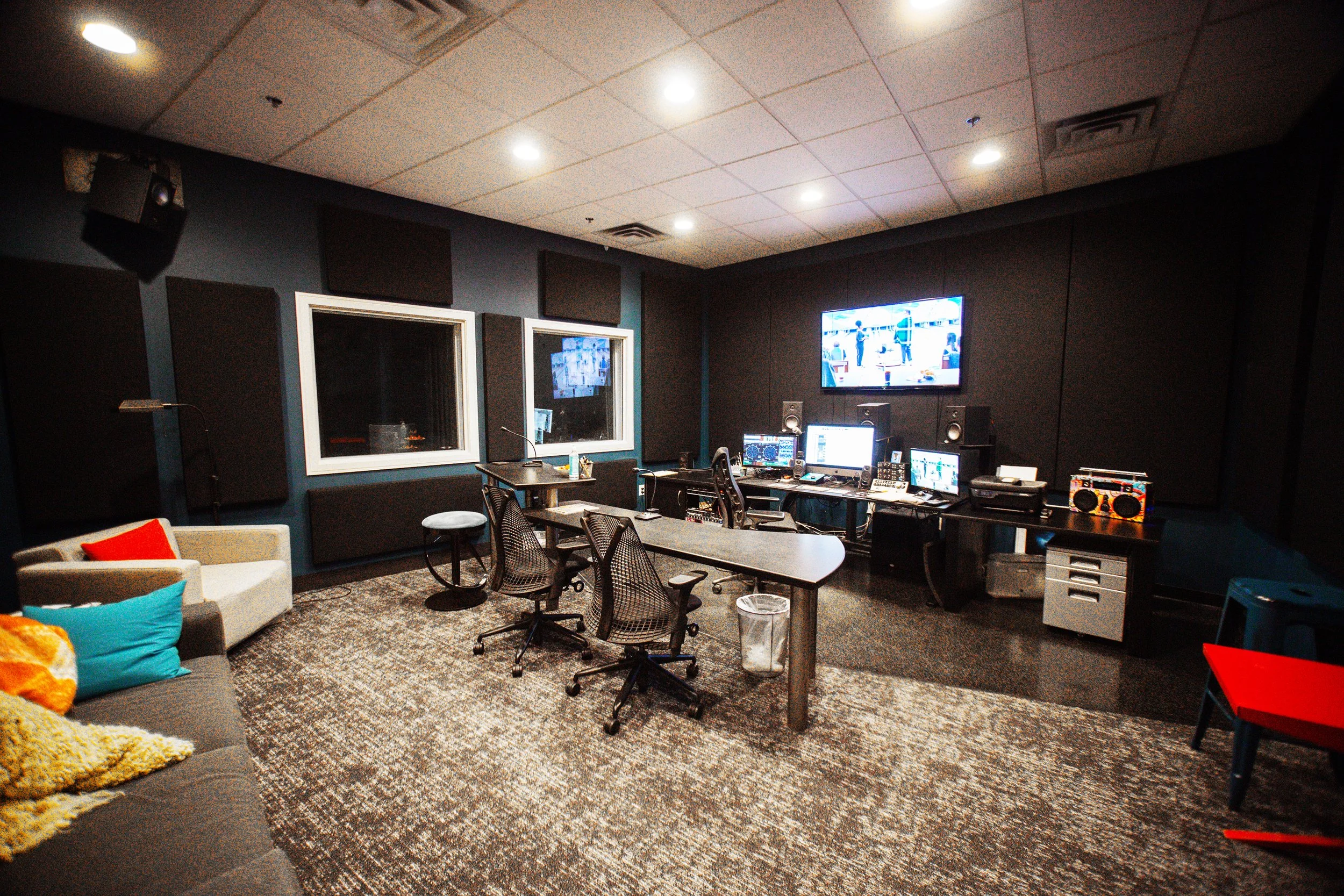 SisterBoss Mix 2 control room with a client desk at center and lounge seating in the back.