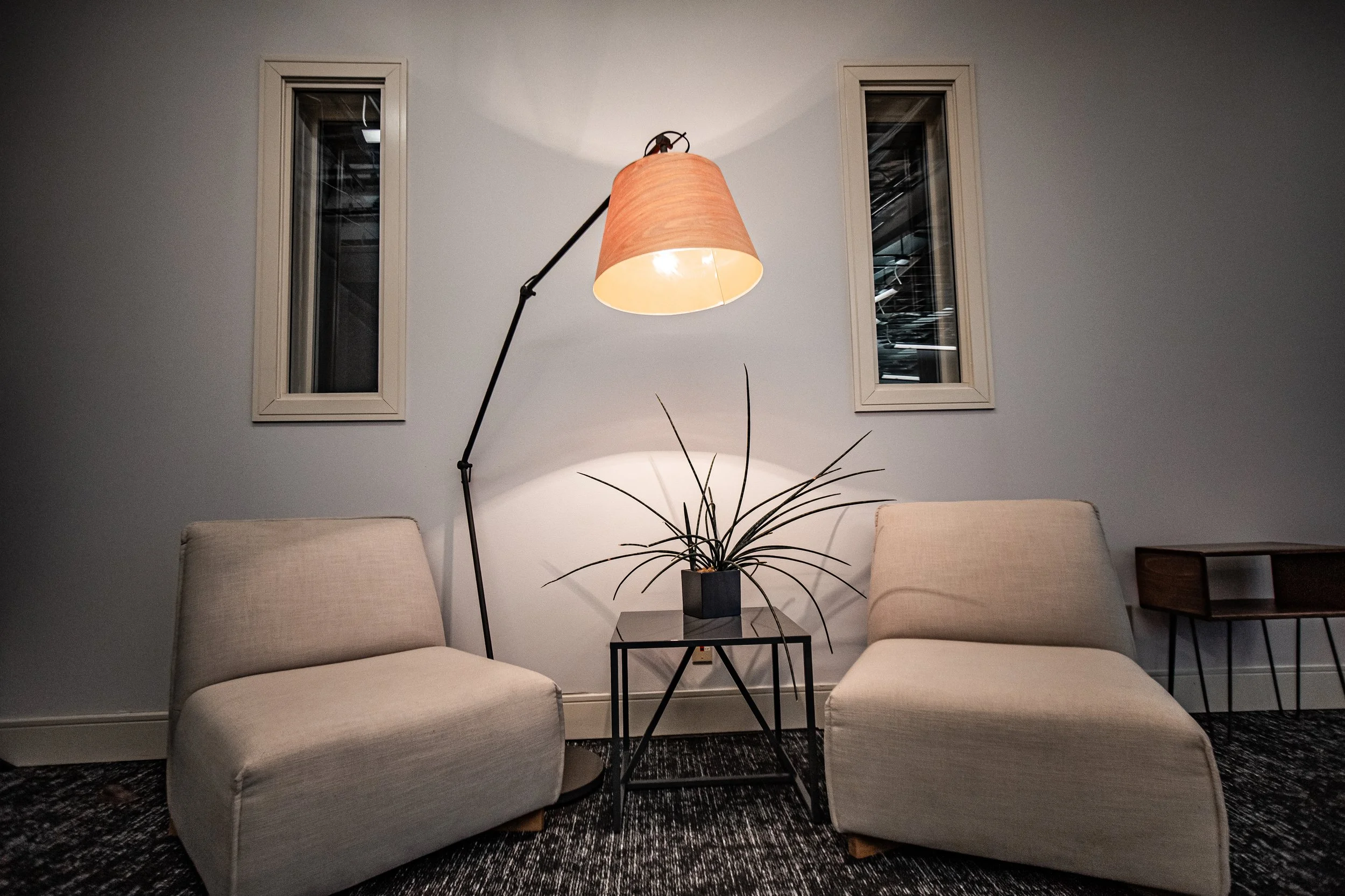 Lobby area inside SisterBoss audio post-production studio with two chairs and a floor lamp