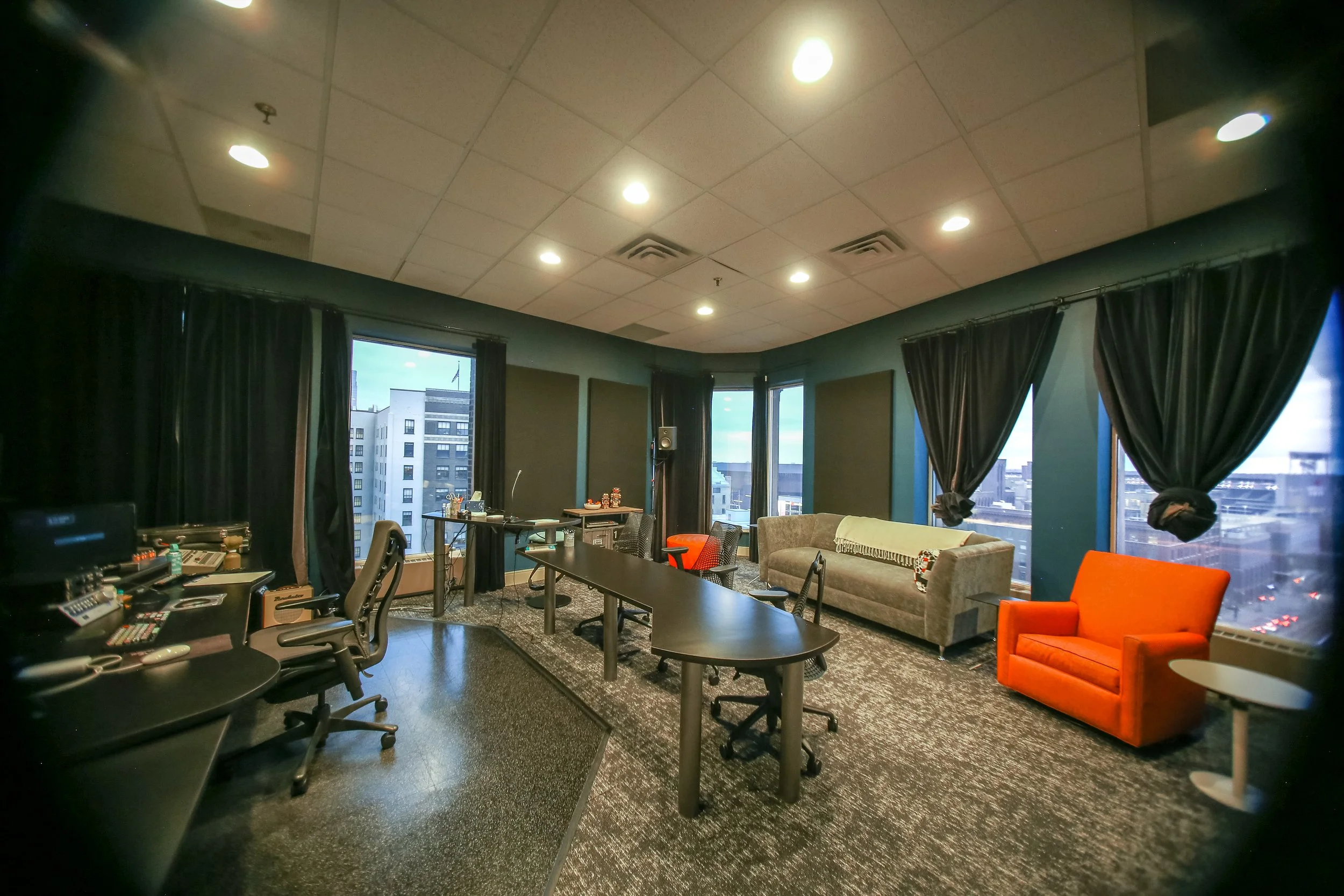 Mix 1 control room with a central client desk, comfortable seating and couch in the back, and windows creating an open, welcoming feel