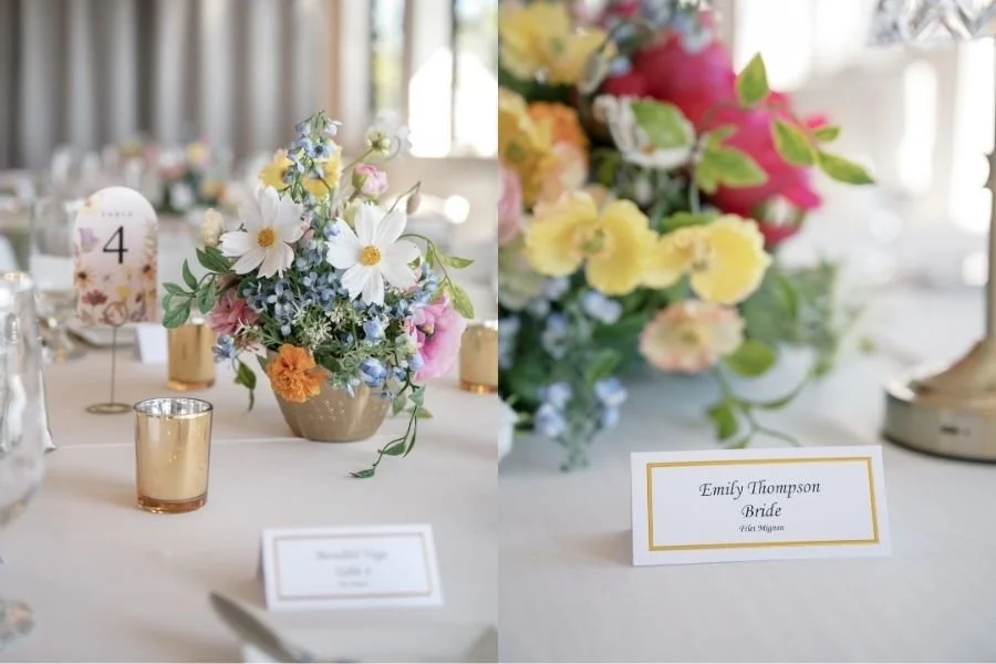 Elegant wedding table setting with vibrant floral centerpiece, gold candle holders, and a table card labeled "Table 4." Name card for bride on right.
