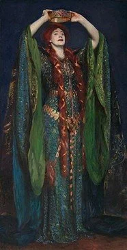 A pale woman with long red hair, garbed in heavily-ornamented green and teal medieval-style dress, her hair wrapped with coppery ribbons, stares wide-eyed into nothing as she lifts a crown to her head, her expression both horrified and horrifying