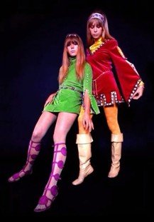 The "Camelot" unics are mini-dresses in red and lime-green velvet. Both have long, elaborate sleeves and are studded. The sleeves either open at the elbow and dangle (green) or are slitted and wide, with yellow silk showing below
