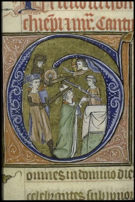 This illustrated capital depicts a praying Thomas a Becket being attacked from behind by two armed figures. Heavenly figures look on in reprimand, including what seems to be the Christian God lifting a cloud to wag a finger at the attackers