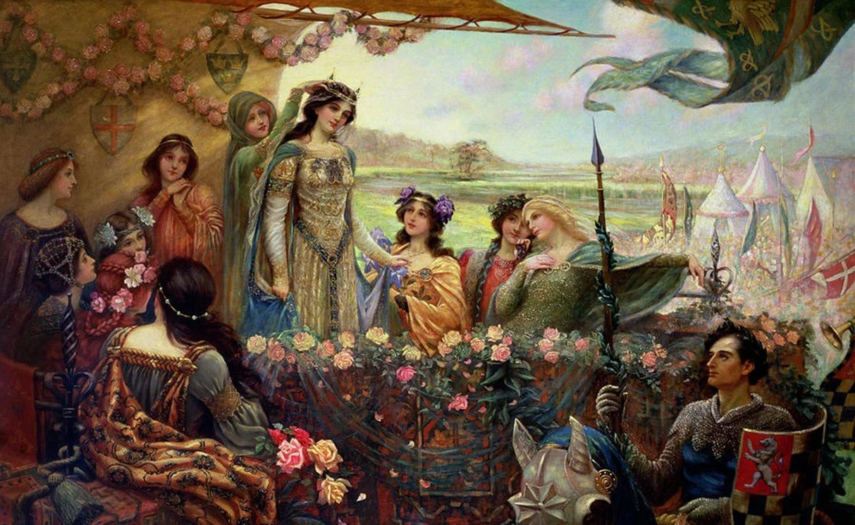 Painting of a group in medievalesque dress in a beflowered pavilion, they are richly arrayed, the queen the most so. She stands as a lady places a crown on her head; Lancelot is the only man present and is in maille his helmet rests nearby