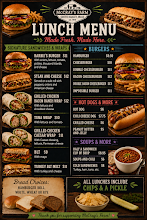 Lunch menu featuring sandwiches, salads, and entrees with prices. Includes options like a cheeseburger, crispy chicken sandwich, and lobster roll. Also shows sides like chips and pickles, and beverages.