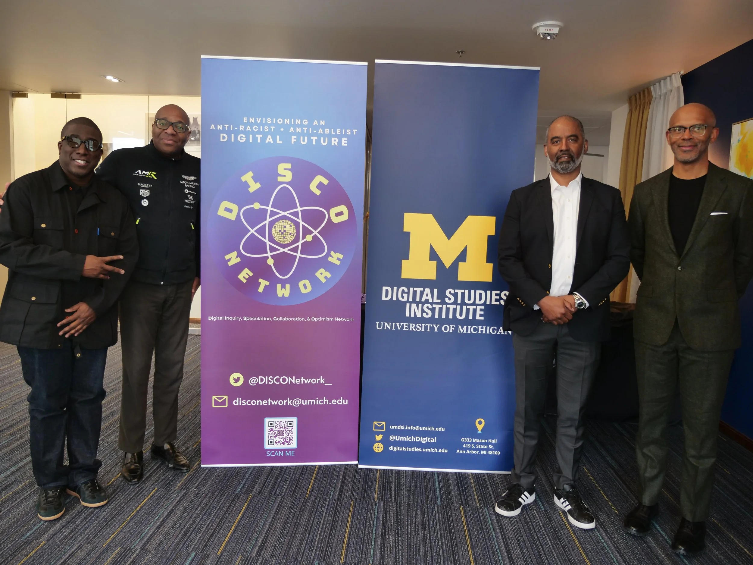 Jonathon Cropper, Kareem Edouard, John Pasmore, Rayvon Fouché posed on either side of the DISCO and DSI banners