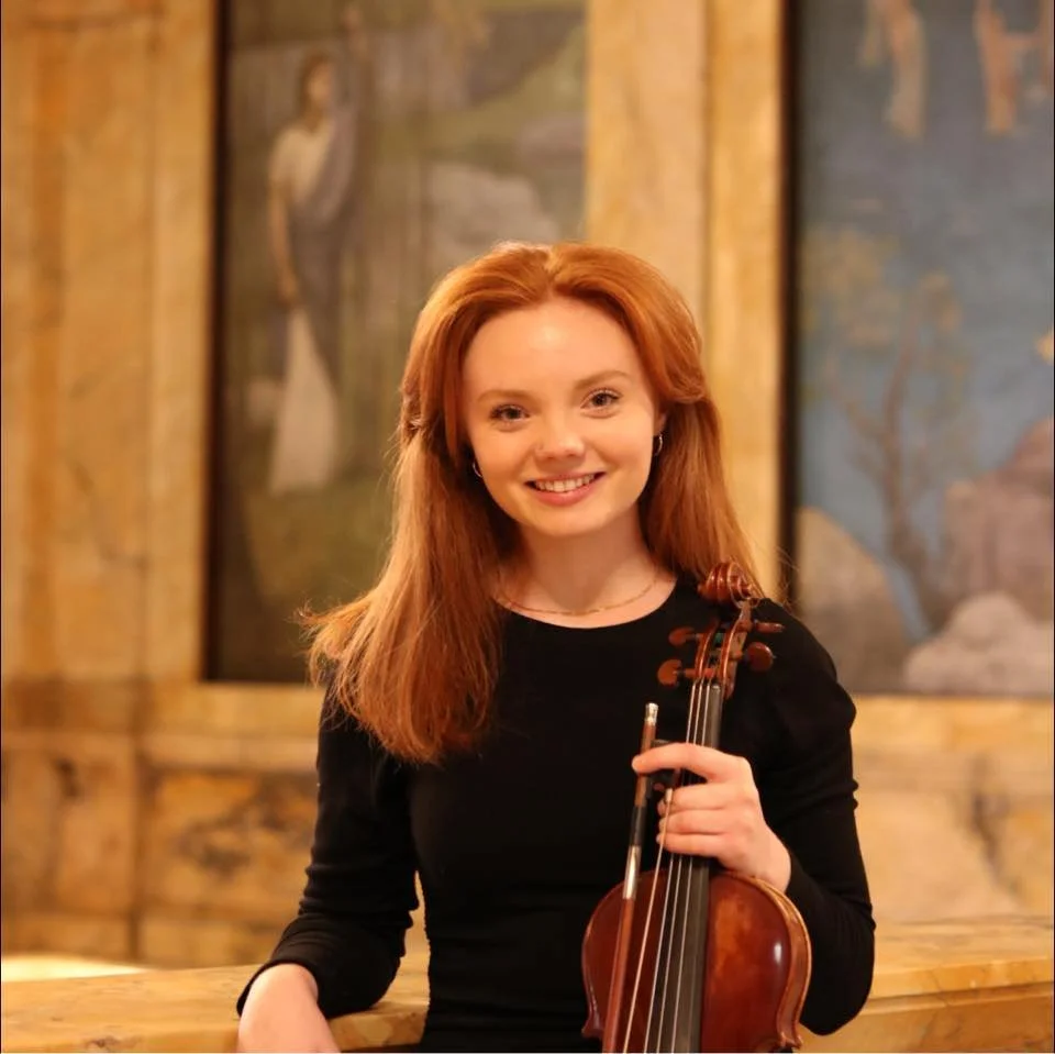 girl with red hair holding violin