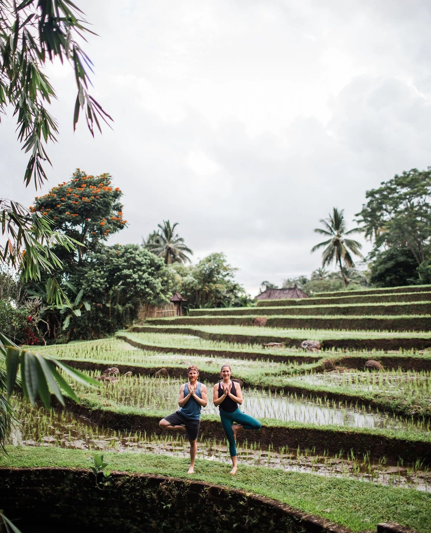 Practicing yoga in Bali is unlike anywhere else in the world. Nestled between emerald rice fields, ancient temples, and sacred volcanoes, the island offers a natural stillness that invites deep inner work. Here, yoga becomes more than a physical prac
