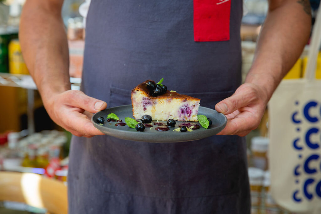 BCBC - Events - Go Blue BC 2020 - Como Taperia - Chef Holding BC Blueberry Basque Cheesecake.jpg