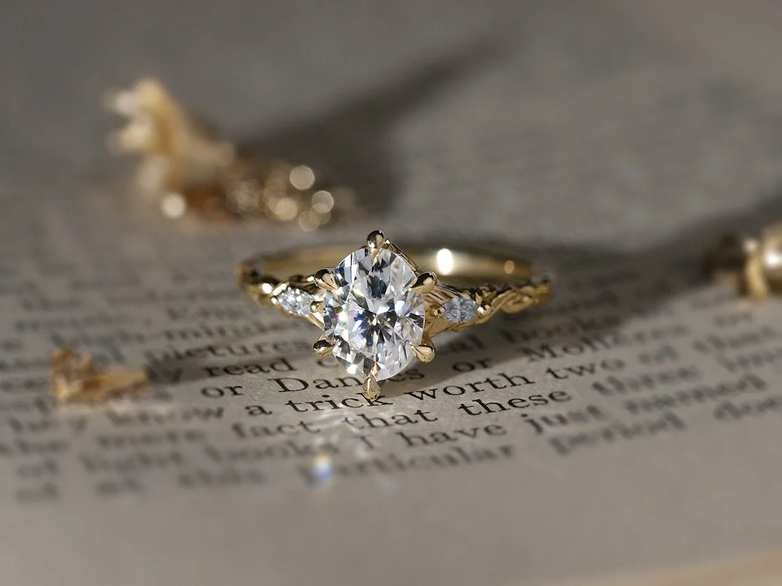 ✨ forest-forged gold and moonbeams for Bridgette 🌿🧚 This ring was adapted for James &amp; Bridgette from one of our previous designs (the Starling ring). An 8 x 6mm oval moissanite clutched between six claws, framed by glittering marquise shoulders