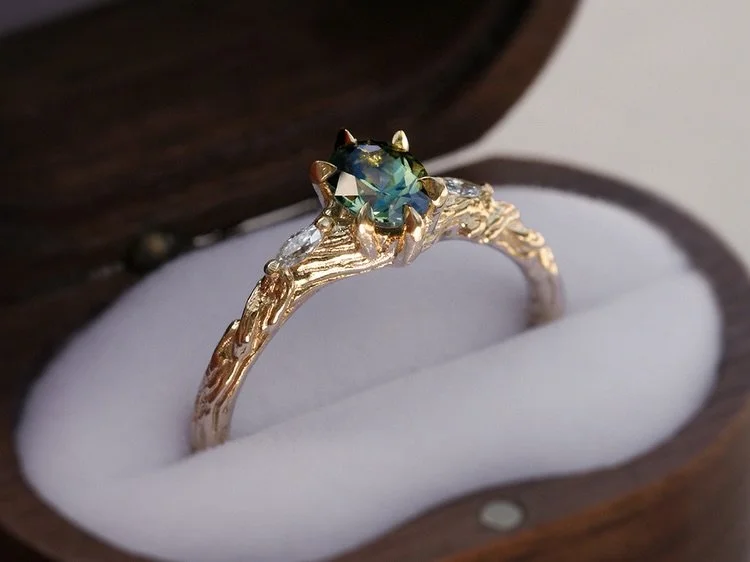 🧚&zwj;♂️🌿✨enchanted timber carved in solid gold holds a sapphire nestled like a lagoon pool and moissanite shoulders like dancing light through leaves. 

the Sapphire Starling ring🧚&zwj;♂️ This one has sold, but email me/send through a Bespoke Inq
