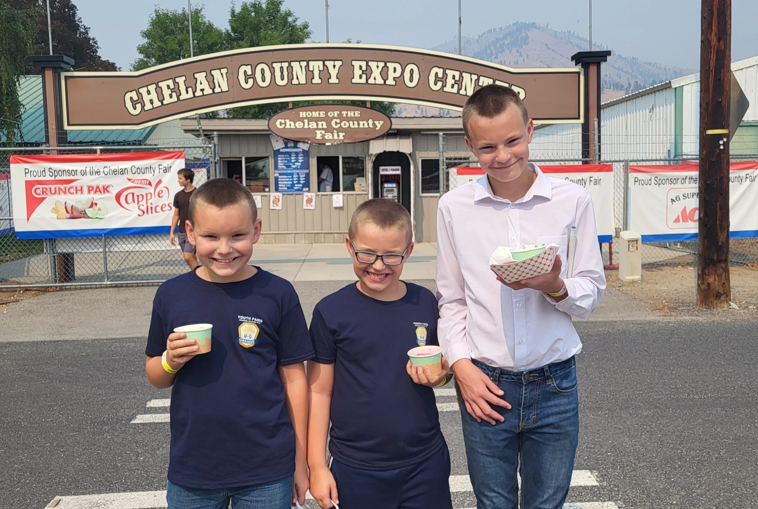 Eli takes Grand Showman in Grange hog drive. Here celebrating with brothers! 2025