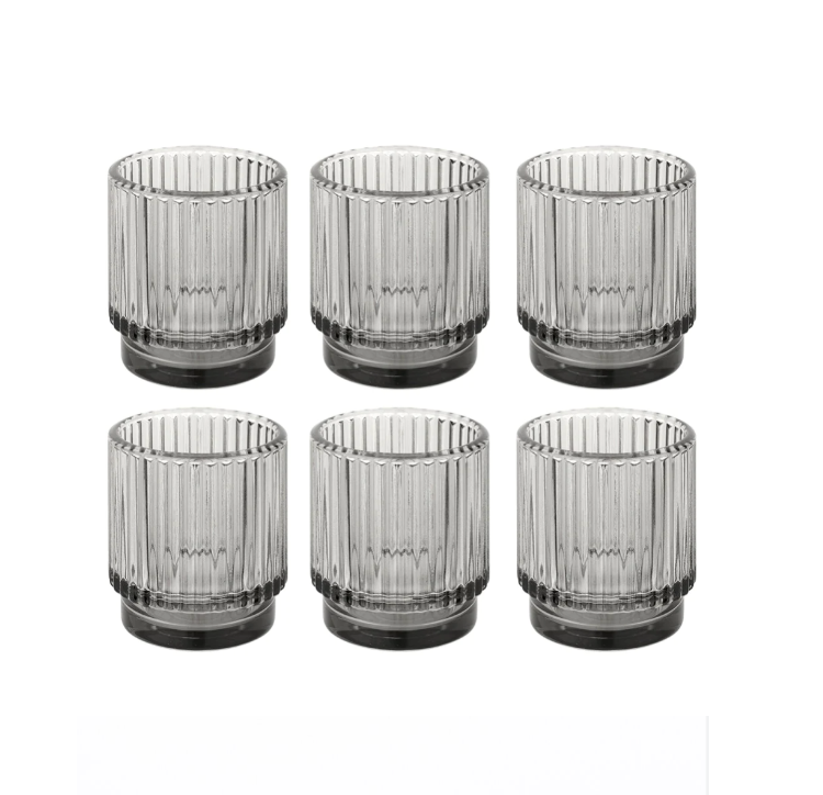 Six identical clear glass tumblers placed in two rows of three against a white background.