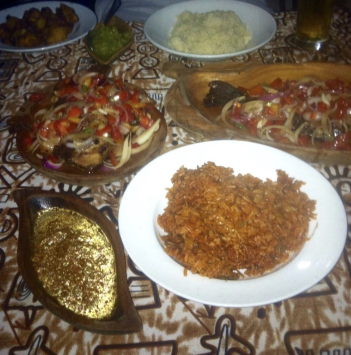  BANKU (POUNDED FERMENTED CORN AND CASSAVA IN HOT WATER MADE INTO A PASTE) SERVED WITH TILAPIA AND PEPPER SAUCE ALONG WITH JOLLOF RICE 