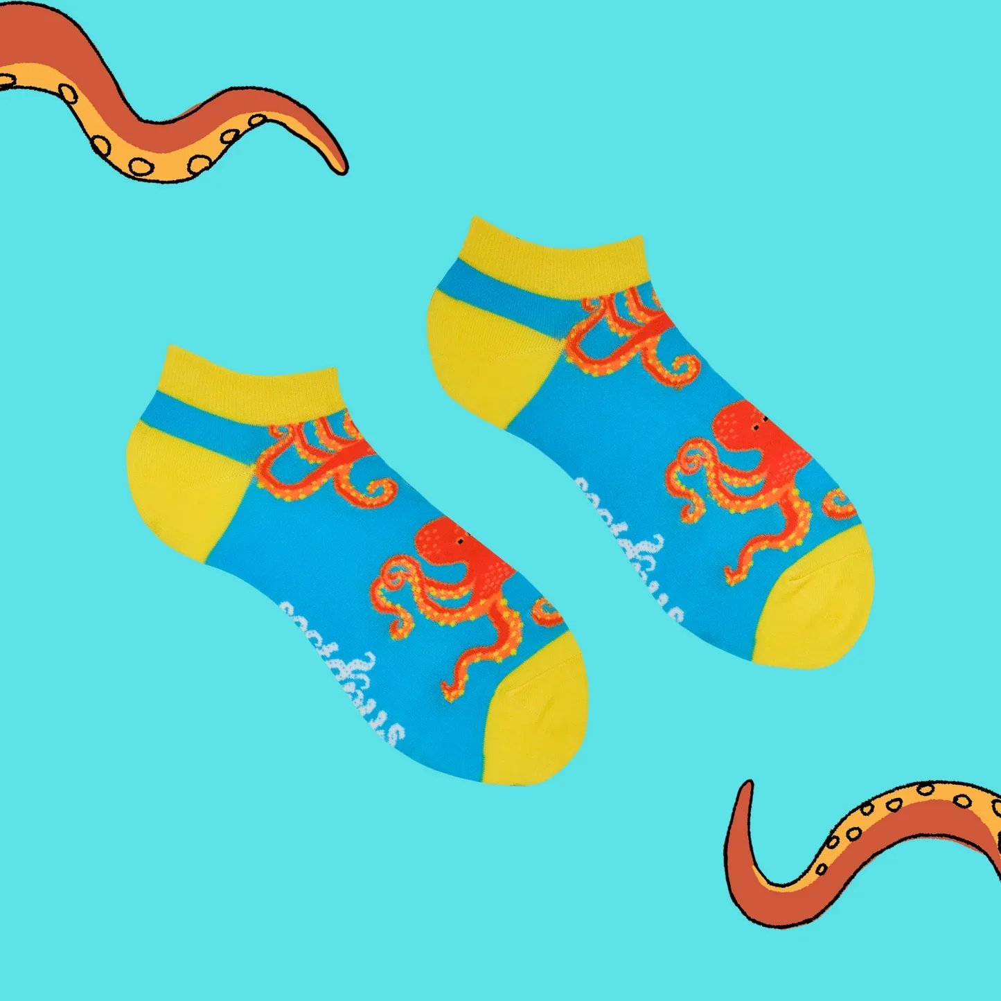 Pair of colorful socks with an octopus design, yellow at the toes and cuffs, blue in the middle, and orange details on a light blue background with orange tentacles.