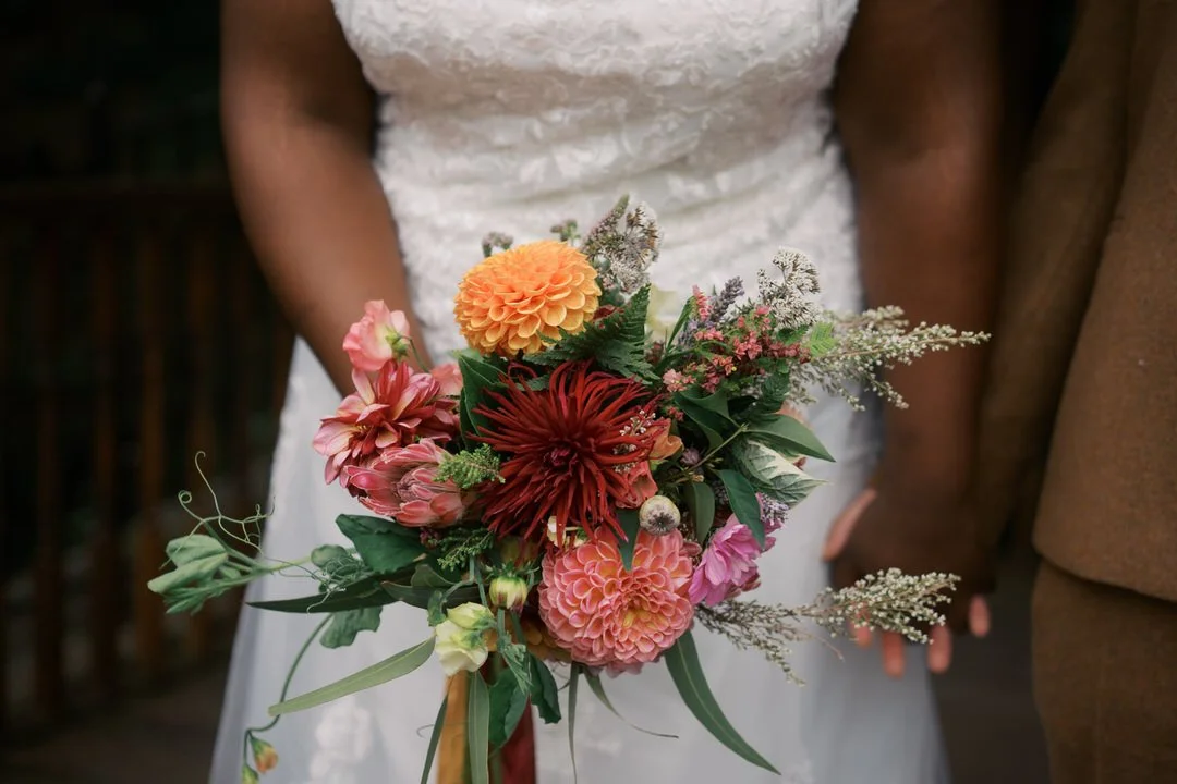  The bride's bouquet of orange, red and pink dahlias 