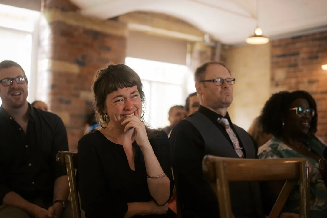  A guest laughing through tears during the wedding ceremony at Bowers Mill 