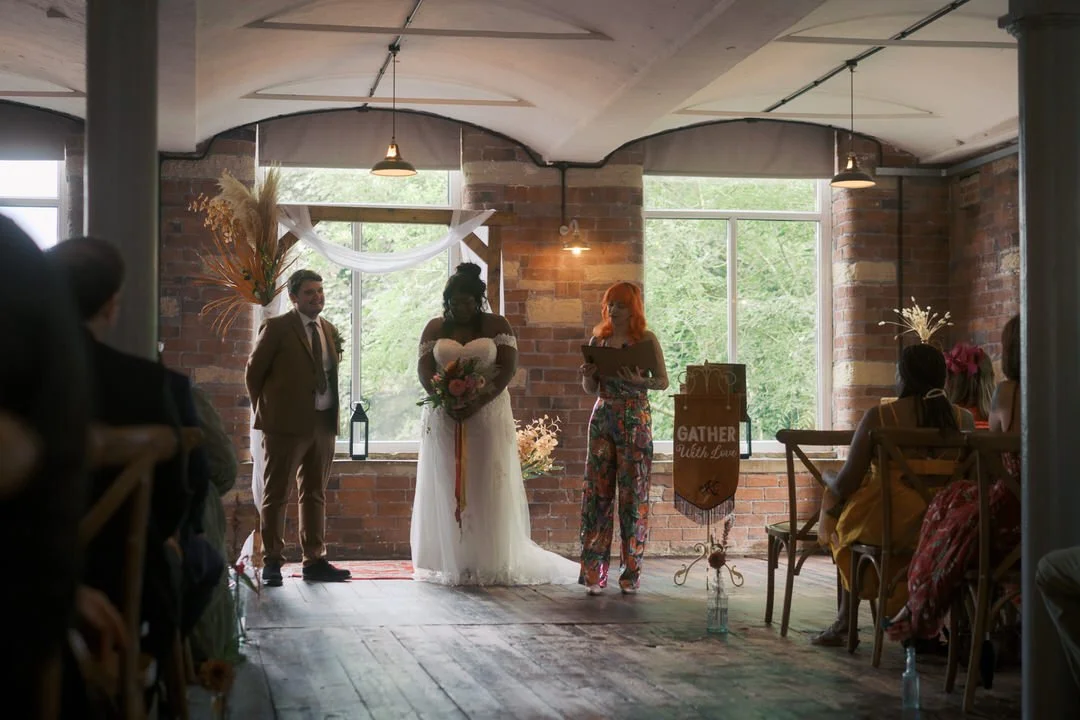  The bride and groom at the front of the ceremony room with the celebrant at Bowers Mill 