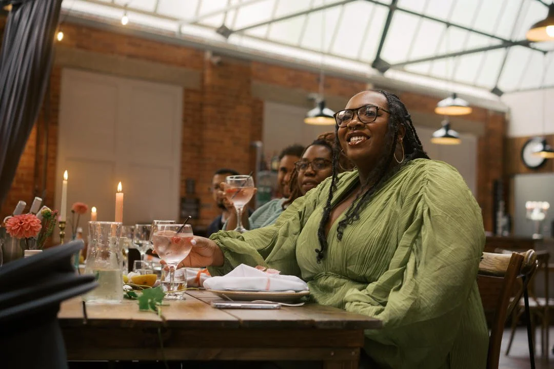  A guest smiling at her table under the glass roof at Bowers Mill 