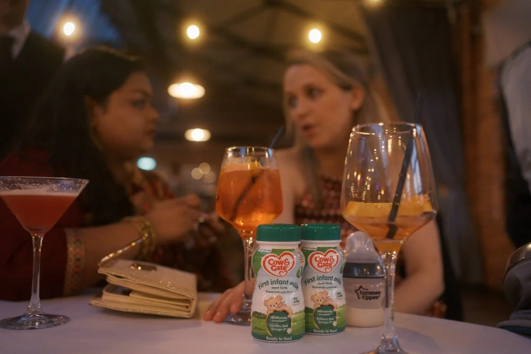  Cocktails and bottles of baby milk on a reception table 