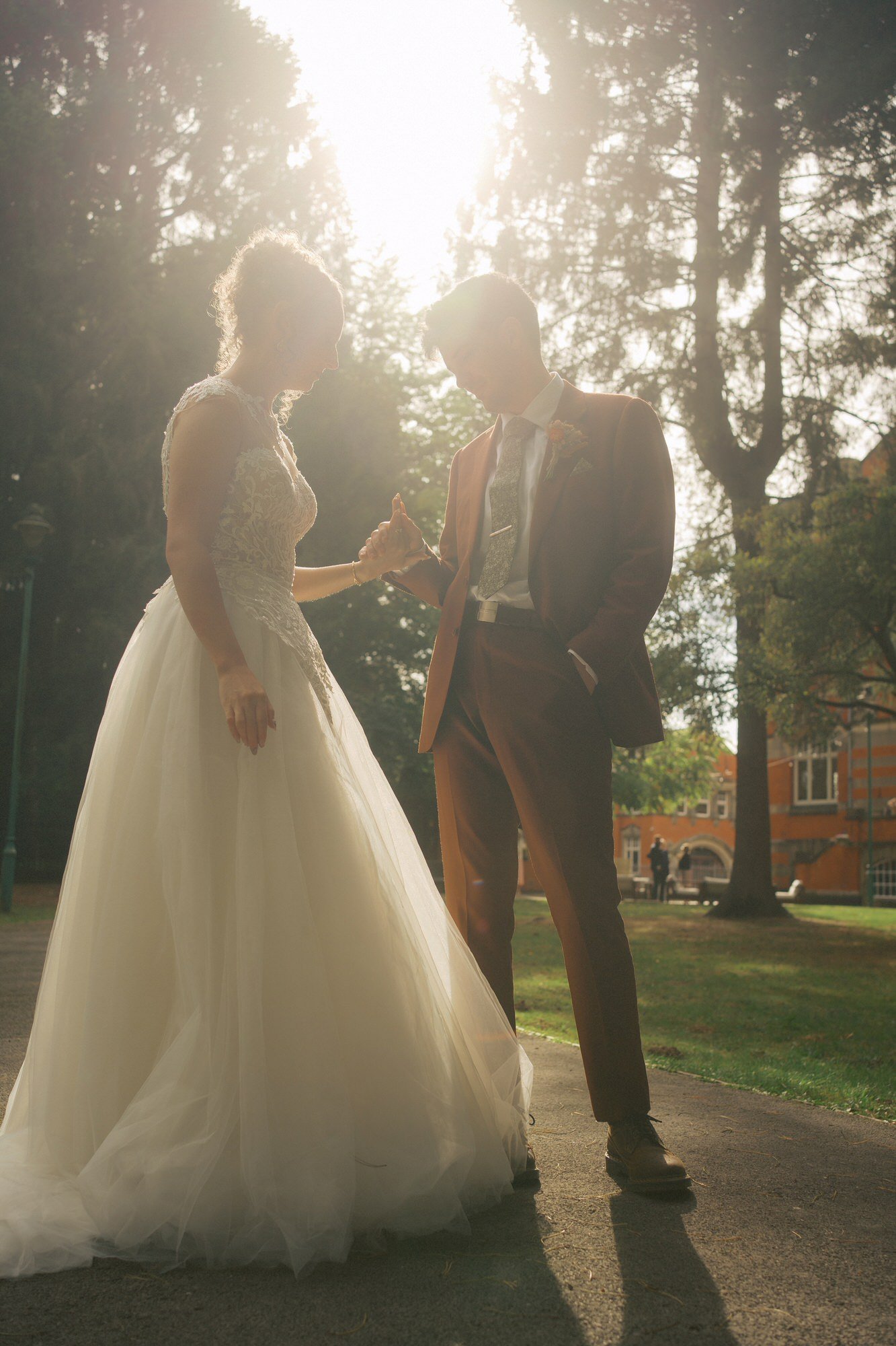  A bride and groom walking along a winding path with The Pumping House behind, Ollerton 
