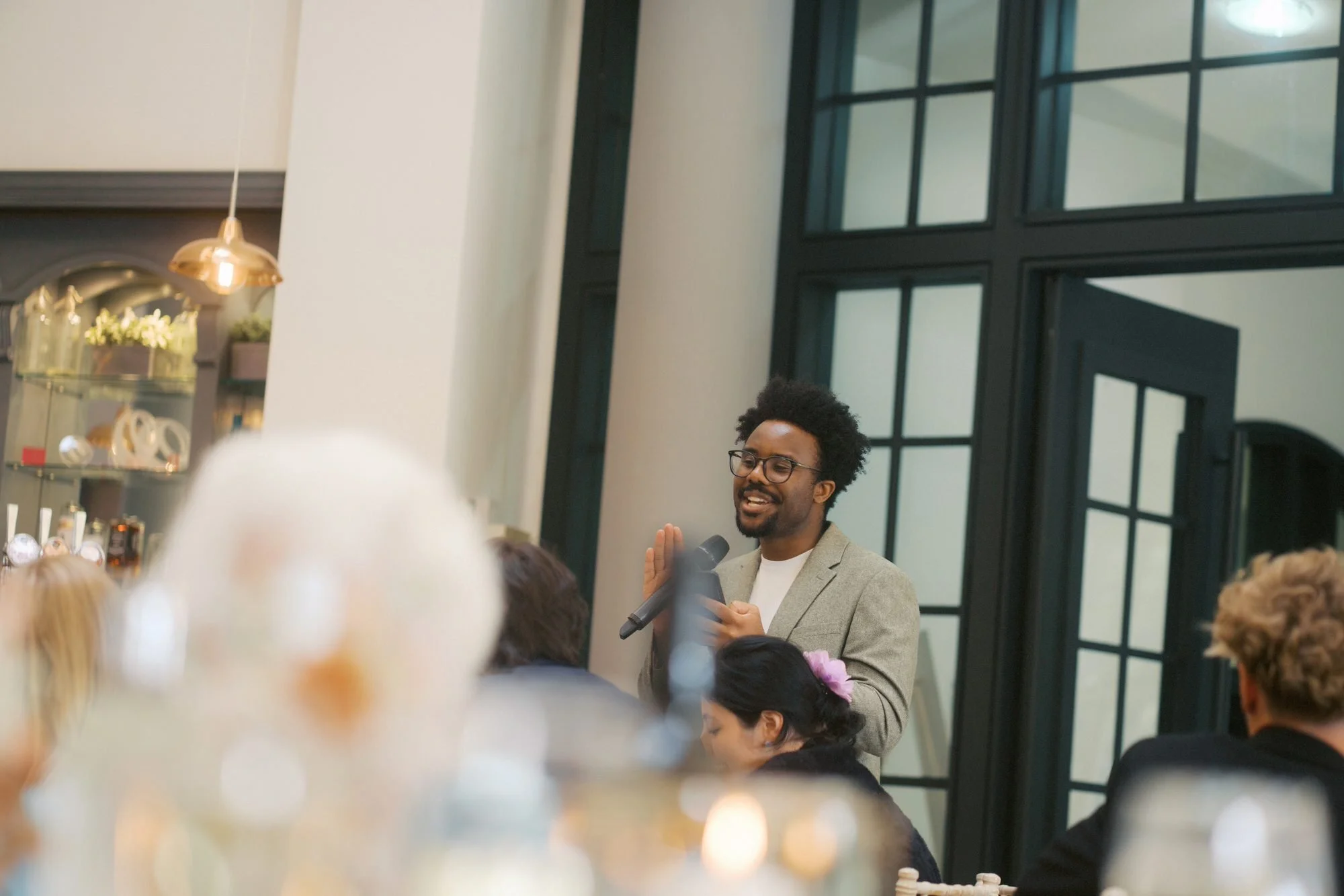  A guest giving a speech into a microphone in the dining hall, The Pumping House, Ollerton 