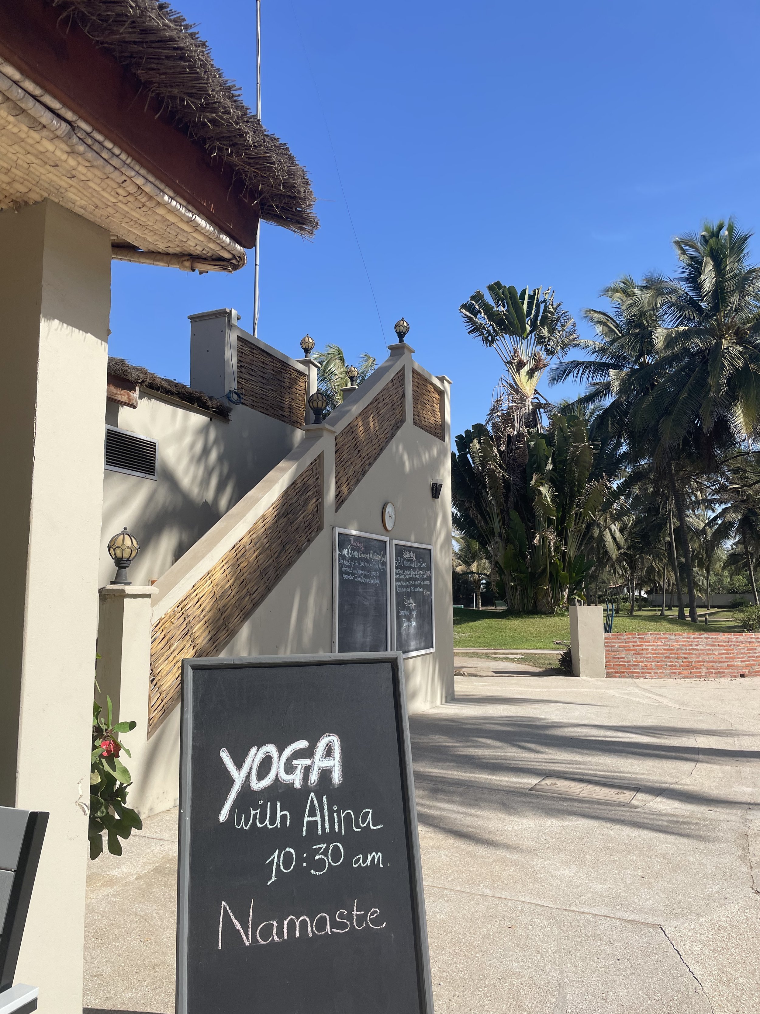 Chalkboard sign advertising yoga with Alina at 10:30 a.m.