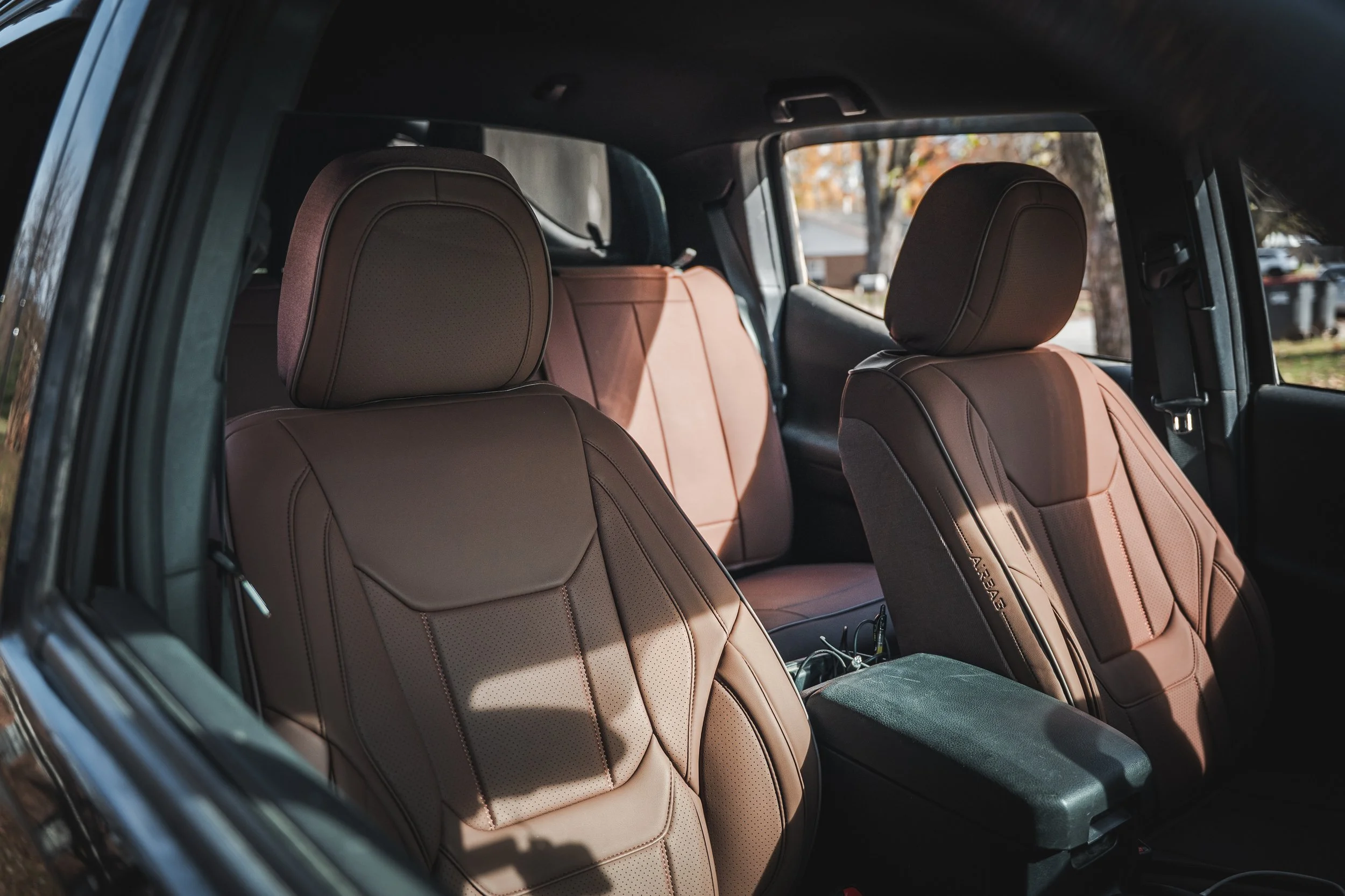 Interior of Toyota Tacoma with dark brown Coverland front and rear seat covers