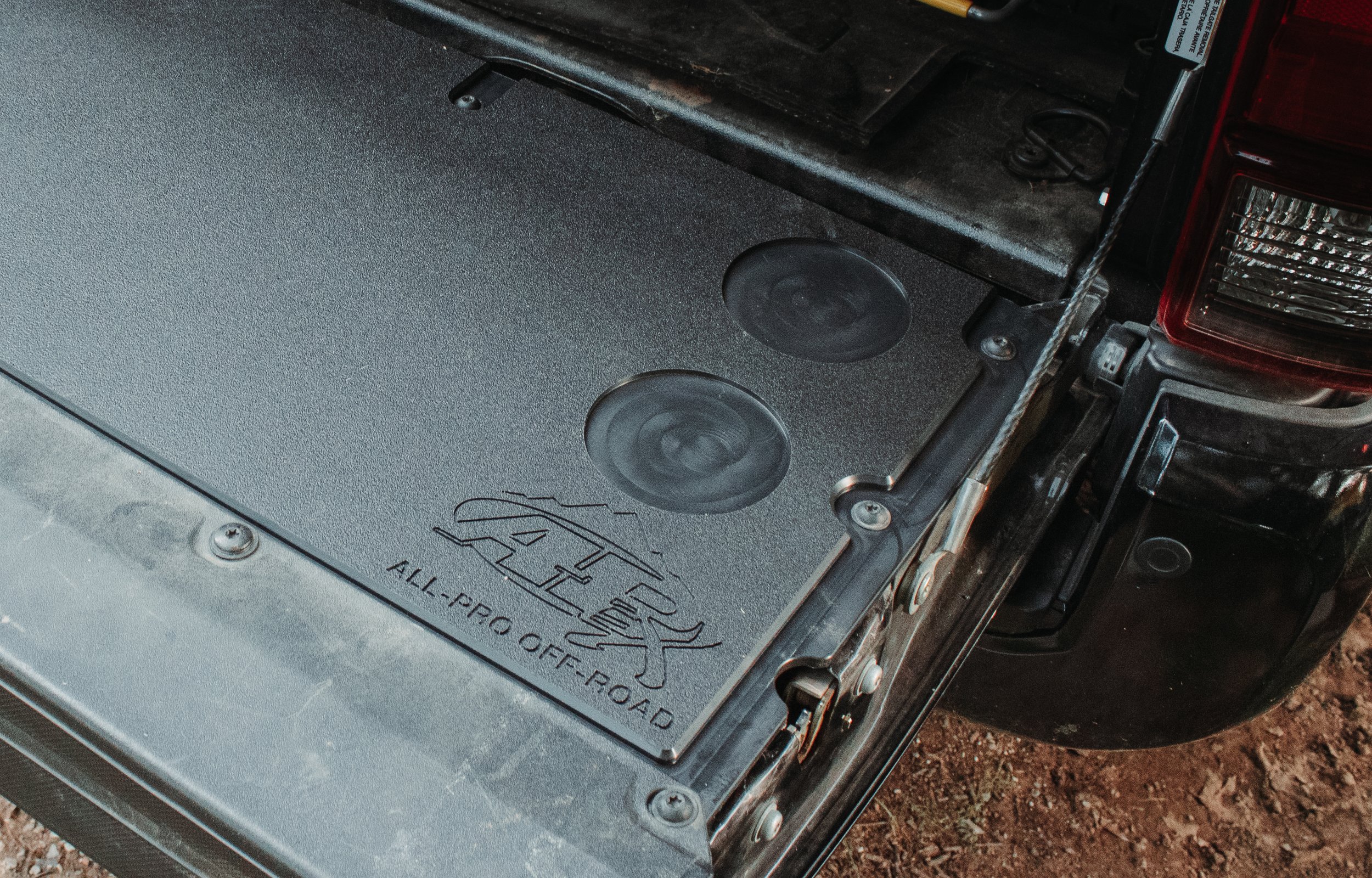 Toyota Tacoma tailgate featuring a tailgate insert with the All-Pro Off-Road logo. 