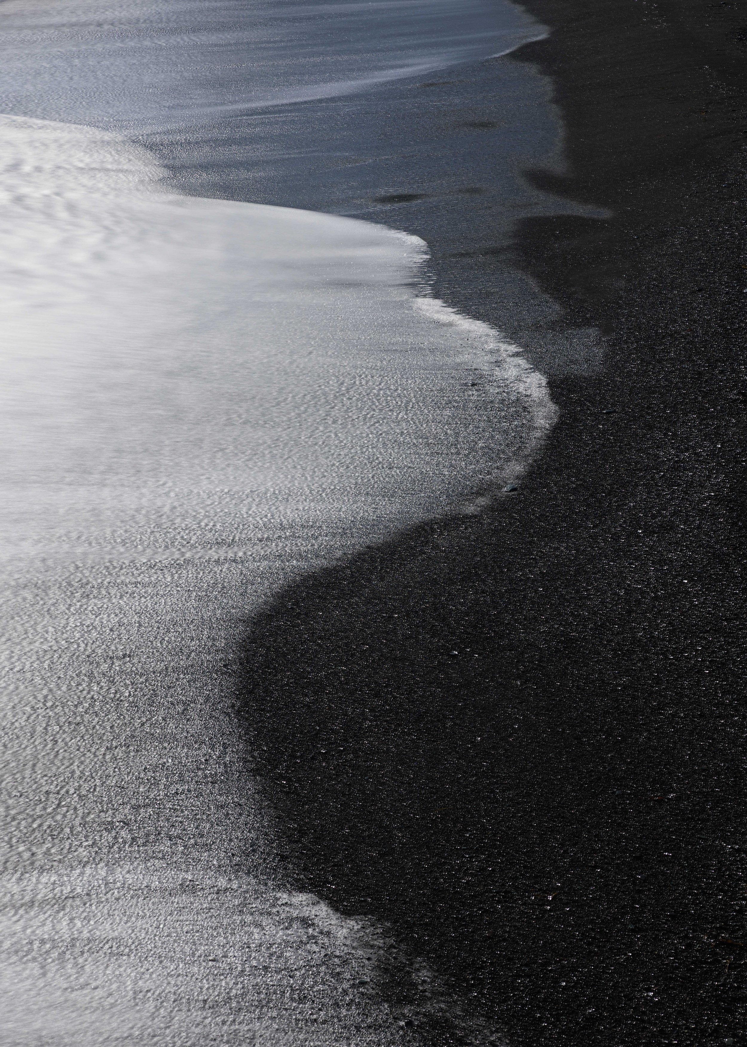 Black, blue & silver meet on a volcanic beach