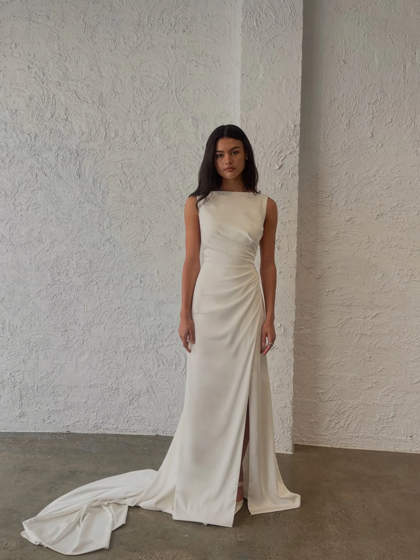 Elegantly alluring, a soft draped high neckline and leg slit creates a soft silhouette and refined look. 

The Haris Gown is available to try in person at our Melbourne and Sydney stockists.