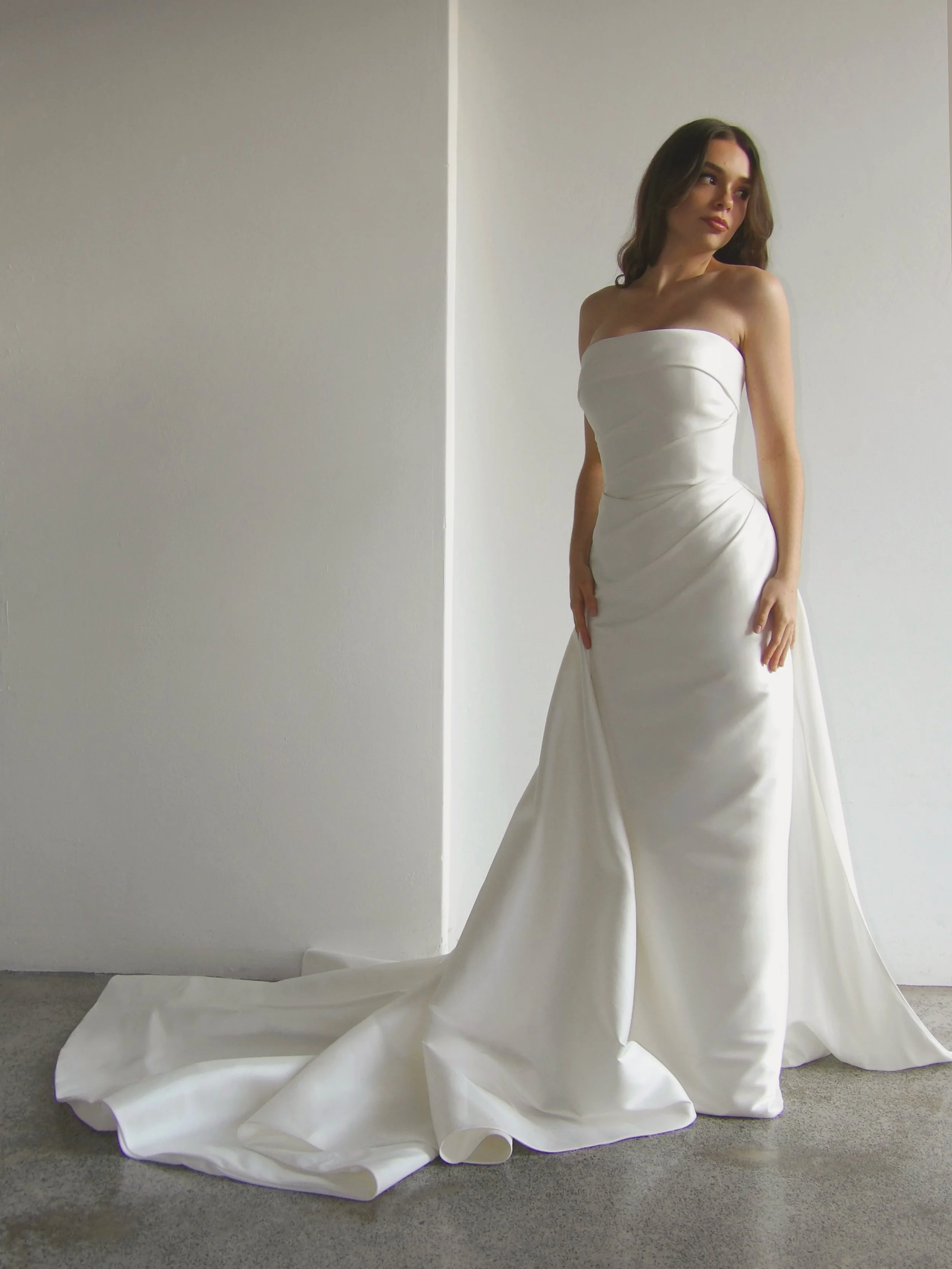 Ava captured in the afternoon light &mdash; romantic, classic, and effortlessly striking. 

The warm ivory, luxe, mikado fabric captures the light with ease and softness. With a subtle lustre on a matte-base fabric, paired with chic draping detailing