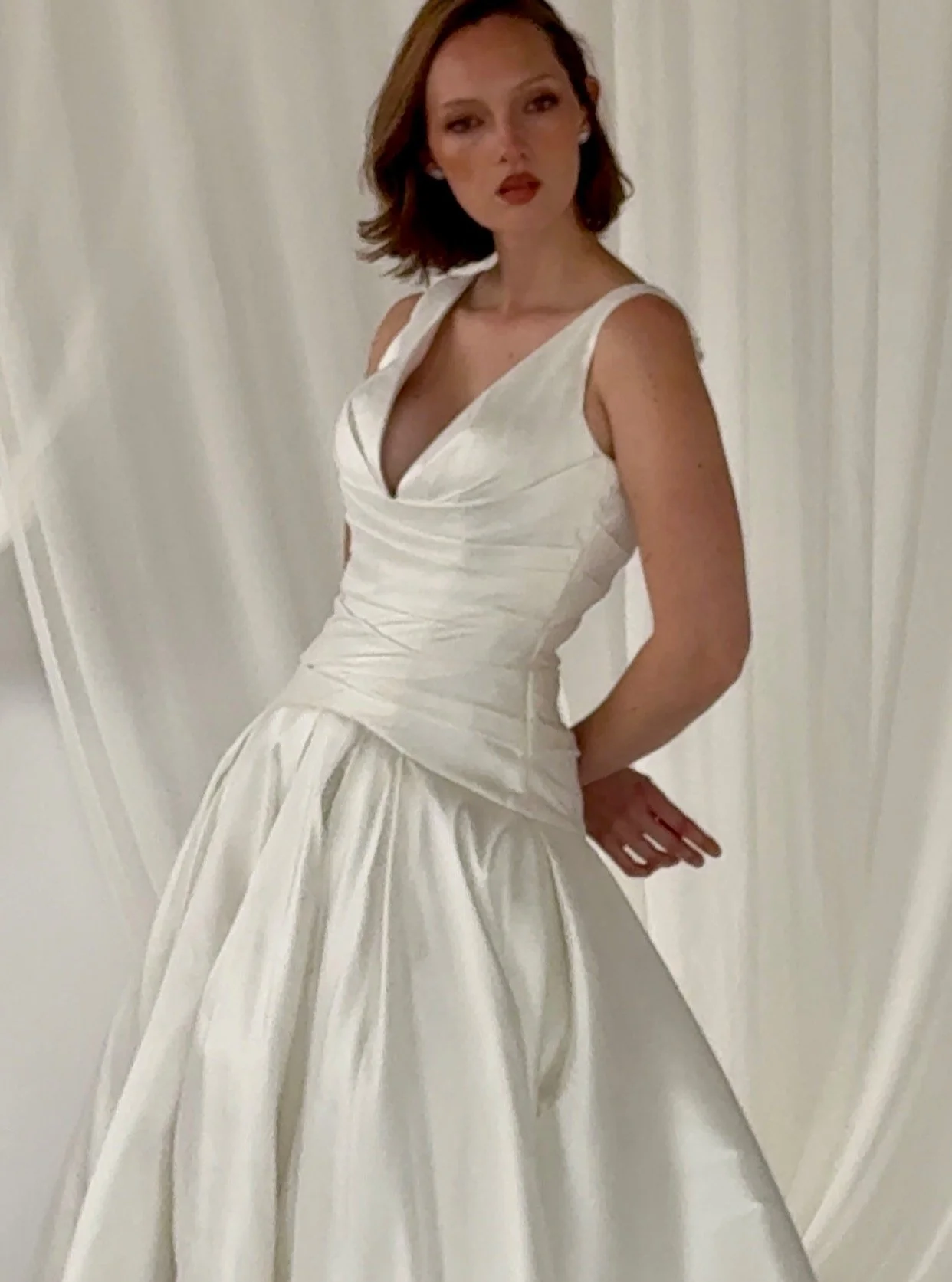 Evie Gown is both refined and effortlessly chic. Perfect choice for the modern bride seeking understated sophistication.