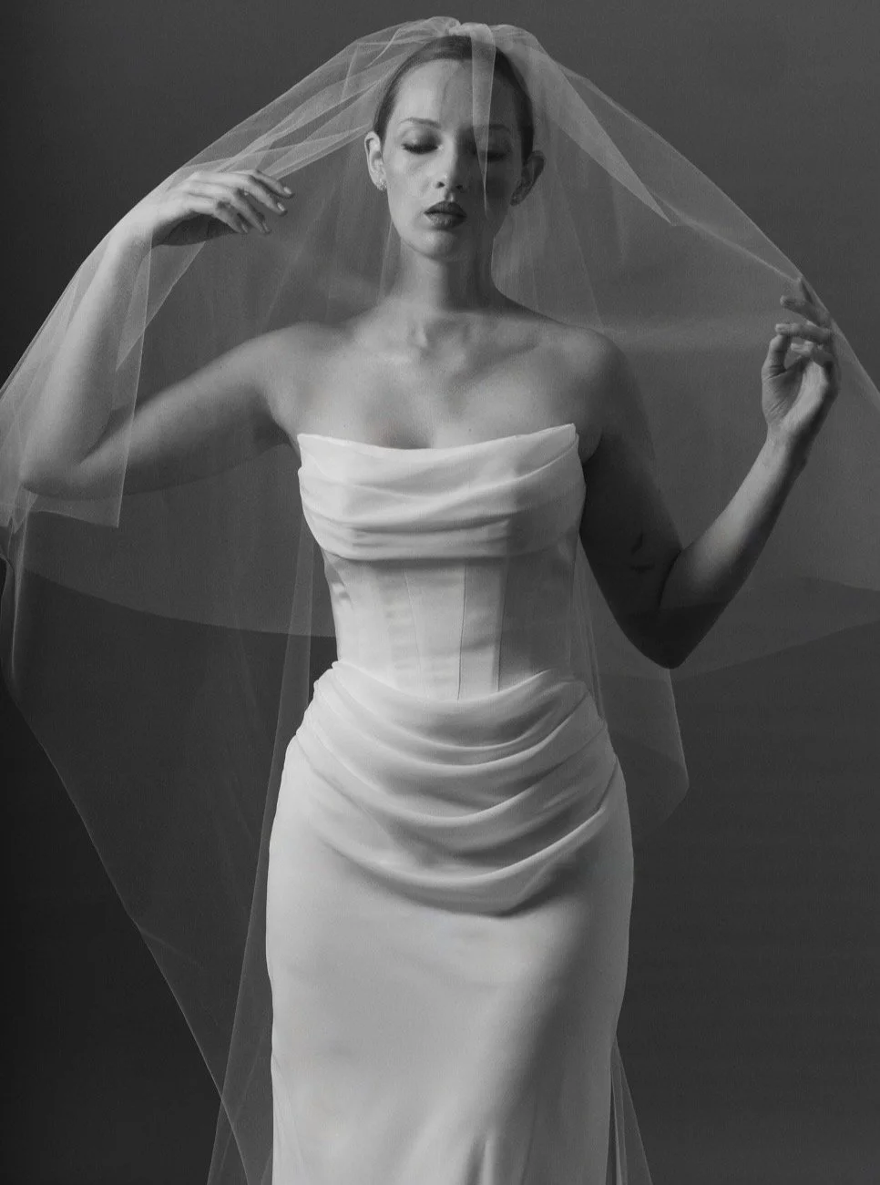 Eloise II is veiled in modern romance. 
Sculpted corsetry, fluid draping, and an ethereal veil come together in a study of softness and structure. Timeless bridal, with a distinctly contemporary point of view. The veil edit coming to Curator The Labe