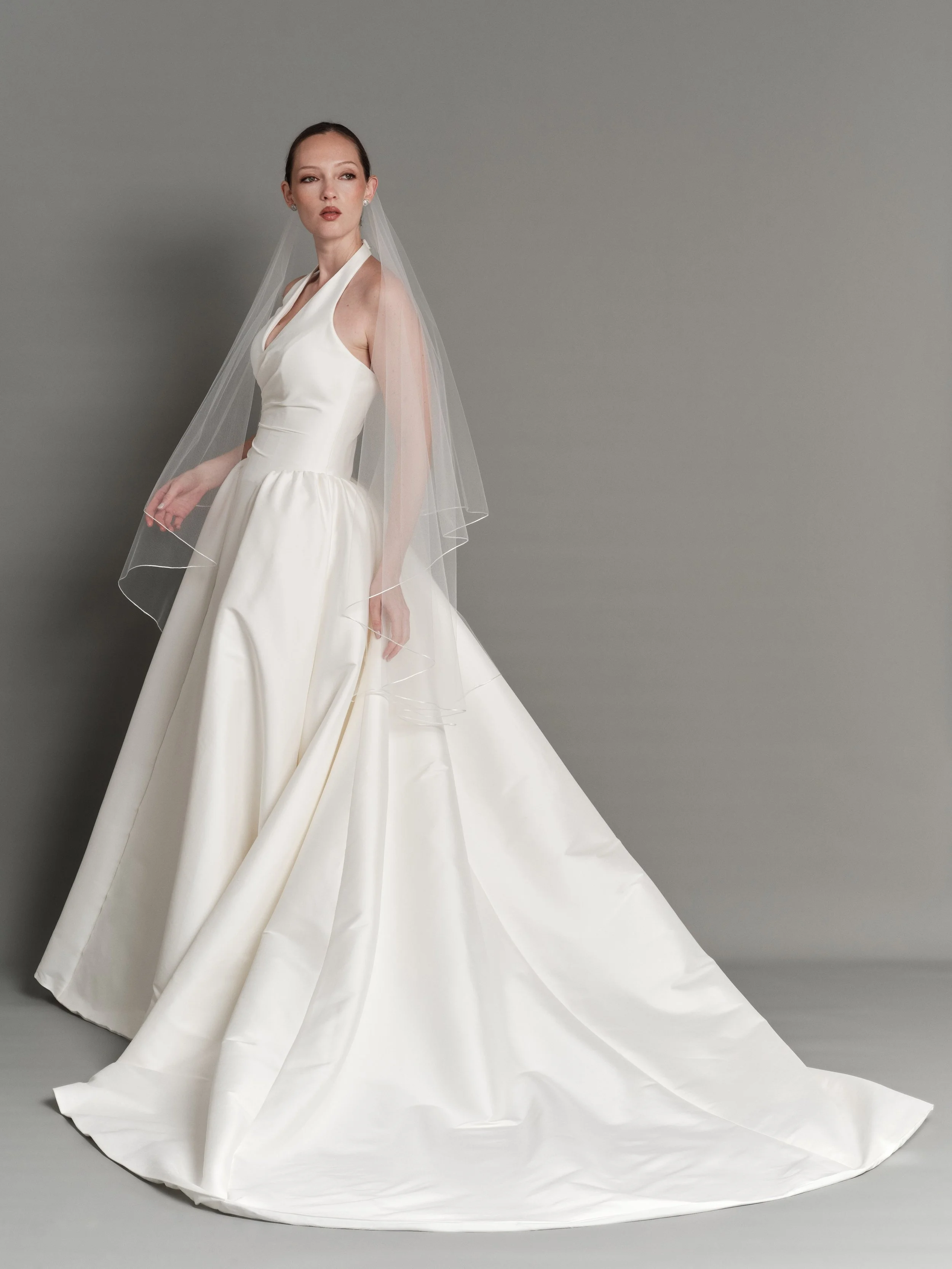 Presenting Lou Lou a modern interpretation of timeless bridal elegance
Clean lines and considered proportions create a silhouette that feels both refined and effortless
Paired with our thin satin edge fingertip veil.