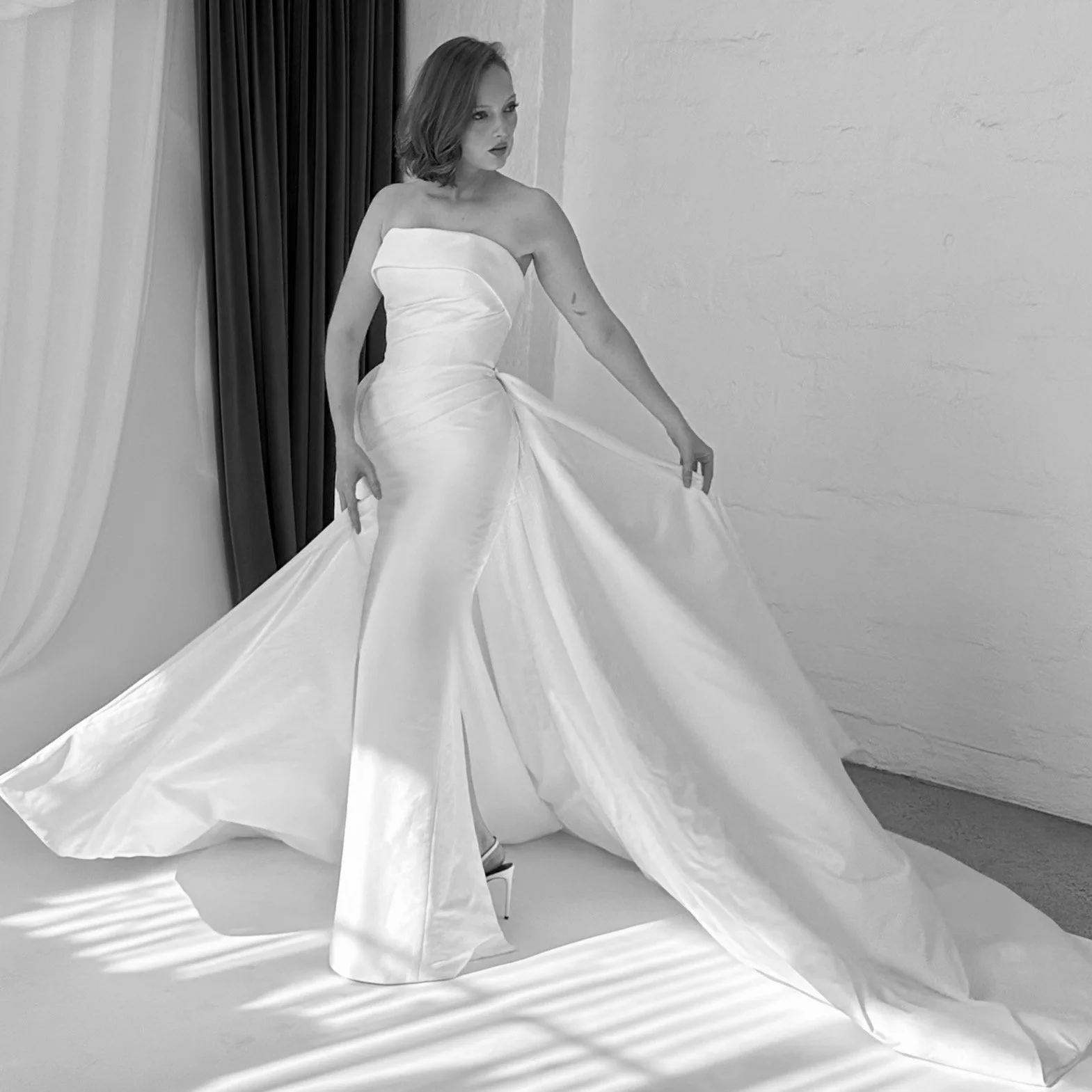 Sculptural, sophisticated, and designed for impact. Ava pairs a beautifully draped strapless silhouette with a dramatic detachable overskirt, transforming from sleek and refined to unapologetically grand.
Modern bridal with an old-world sense of glam