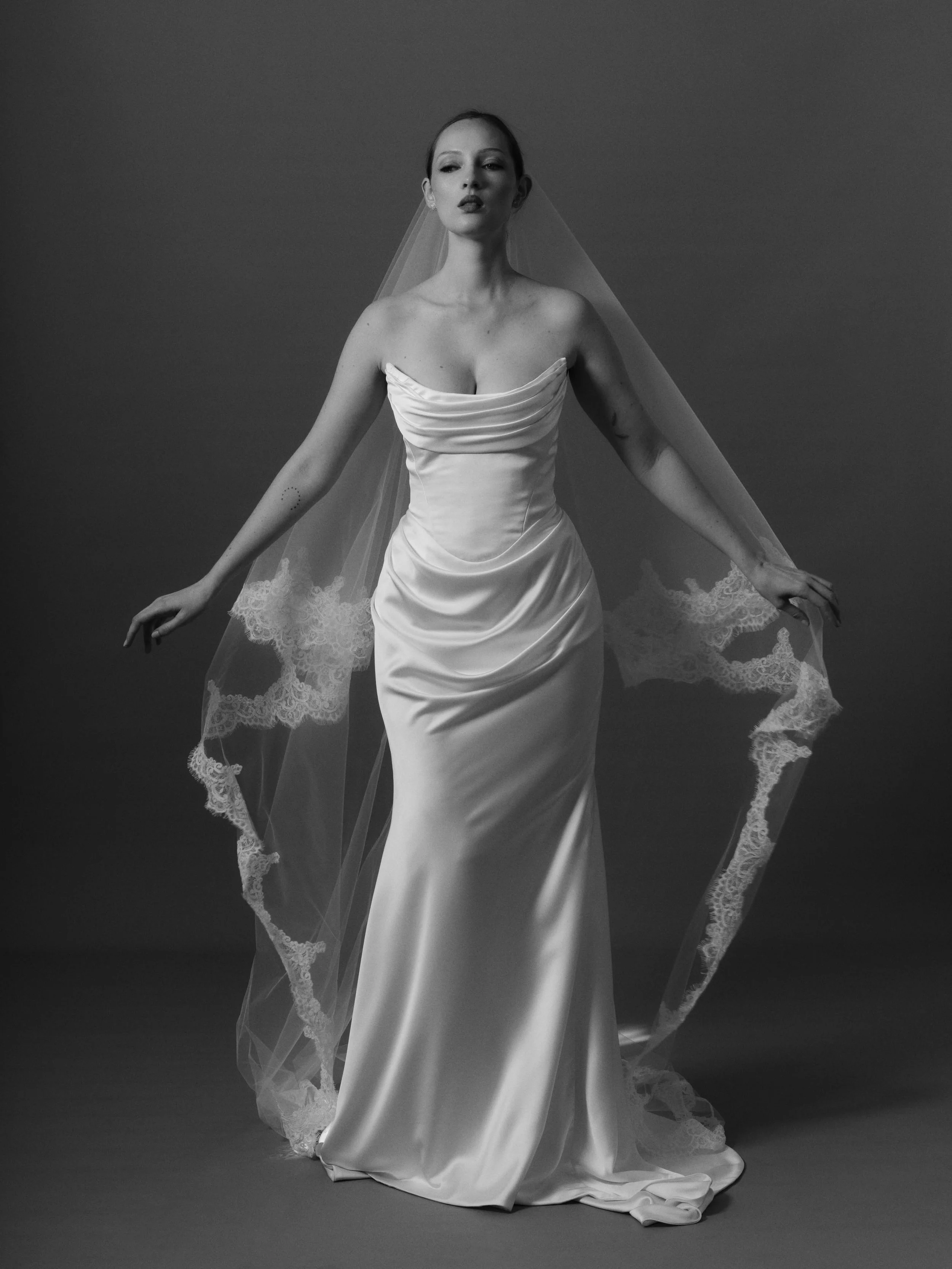 Clea, in her element.
Liquid satin, sculpted draping and a silhouette that feels effortlessly undone. Finished with our Chantilly lace edged veil for just the right amount of romance.
Soft, sensual, a little rebellious. Moment captured @renatadotjpg 