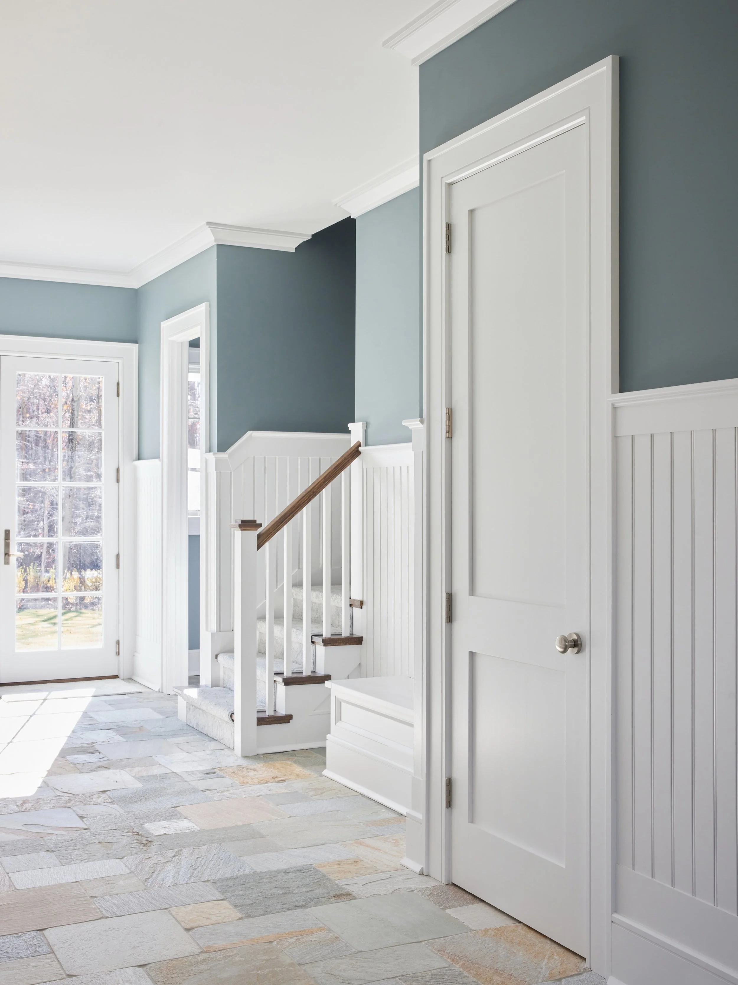 This bright and functional mudroom proves that the hardest working room in the house can also be one of the most beautiful. Natural slate heated floors are sure to keep cold boots and wet paws warm all season long. 

@juliadags 

#haleydesigncompany 
