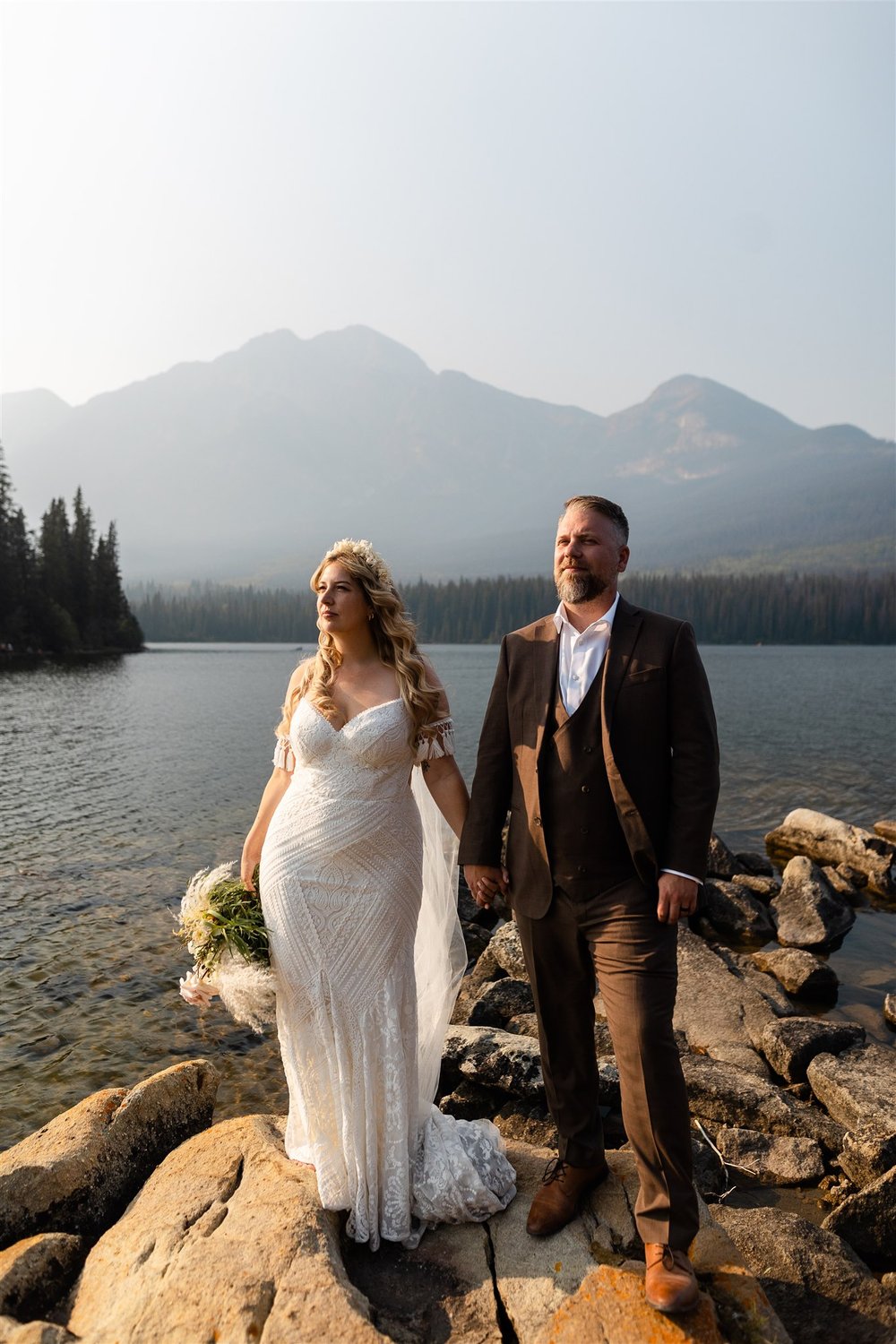  A wedding couple at Pyramid Lake in Jasper National Park after their wedding at the Athabasca Day Use Area. 