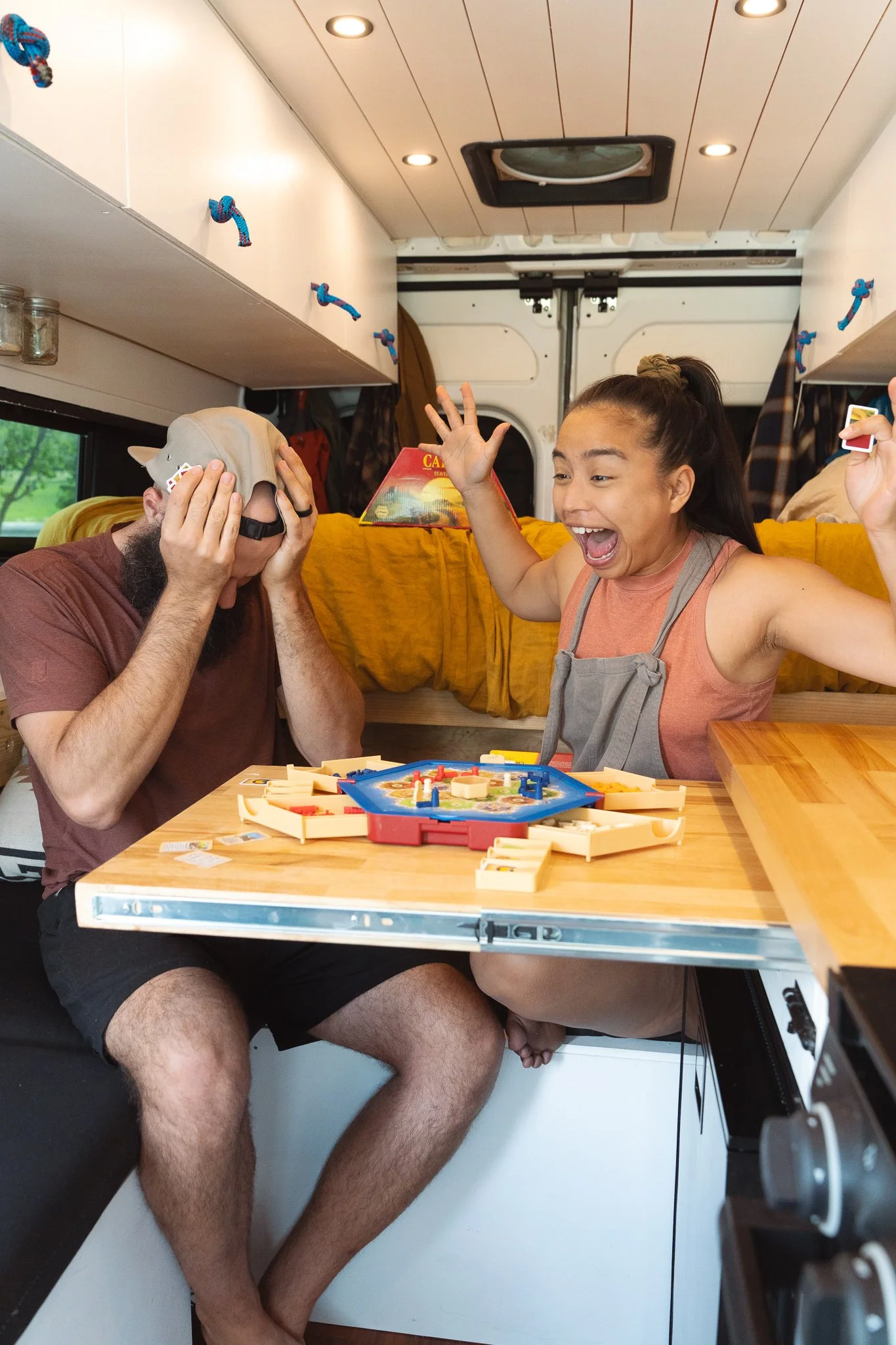 A man sad he is losing a board game to his fiance