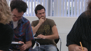 Man looking at cheat notes written on his palm