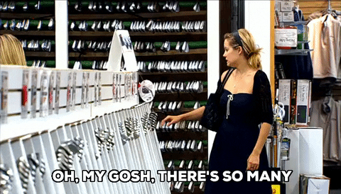 A woman overwhelmed by too many shopping choices
