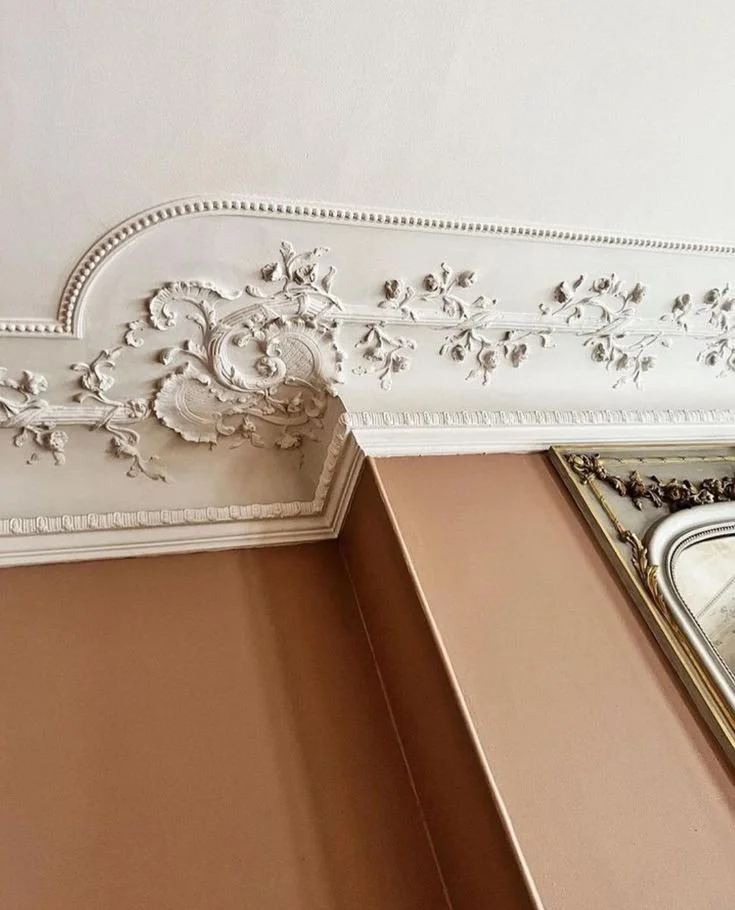 “Elegant ceiling detail with classic beige molding and ornamental trim in traditional architectural interior design”1