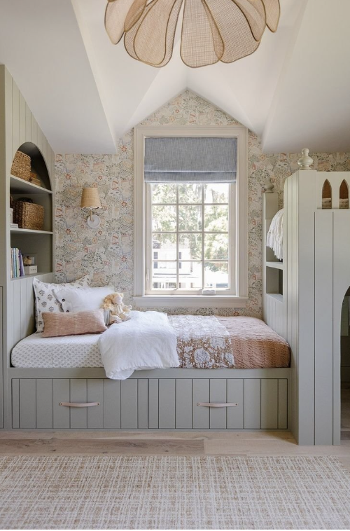 "Cozy children’s bedroom with built-in sage green bunk beds, arched ceiling, floral wallpaper, and woven pendant light"
