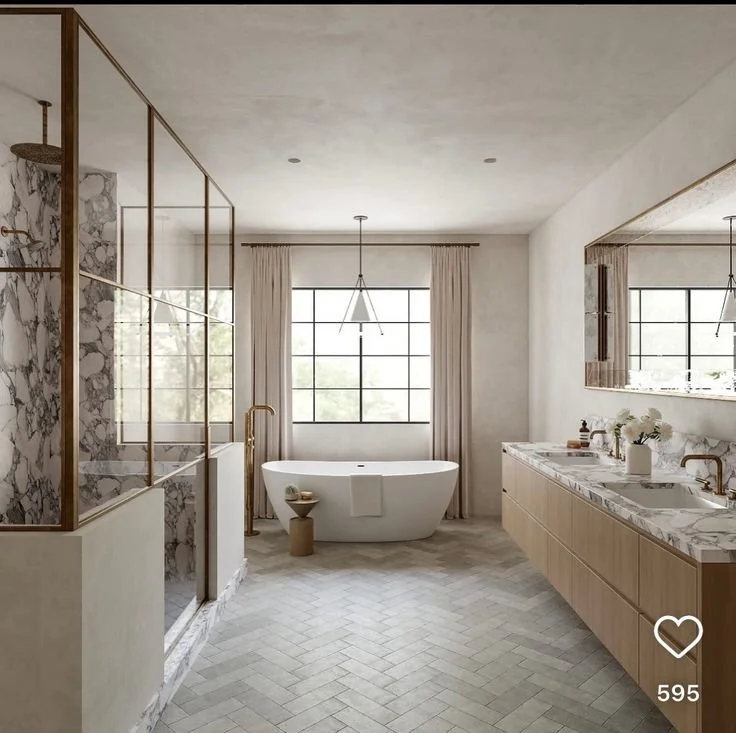 Spacious luxury bathroom with freestanding tub, marble double vanity, and glass shower enclosure