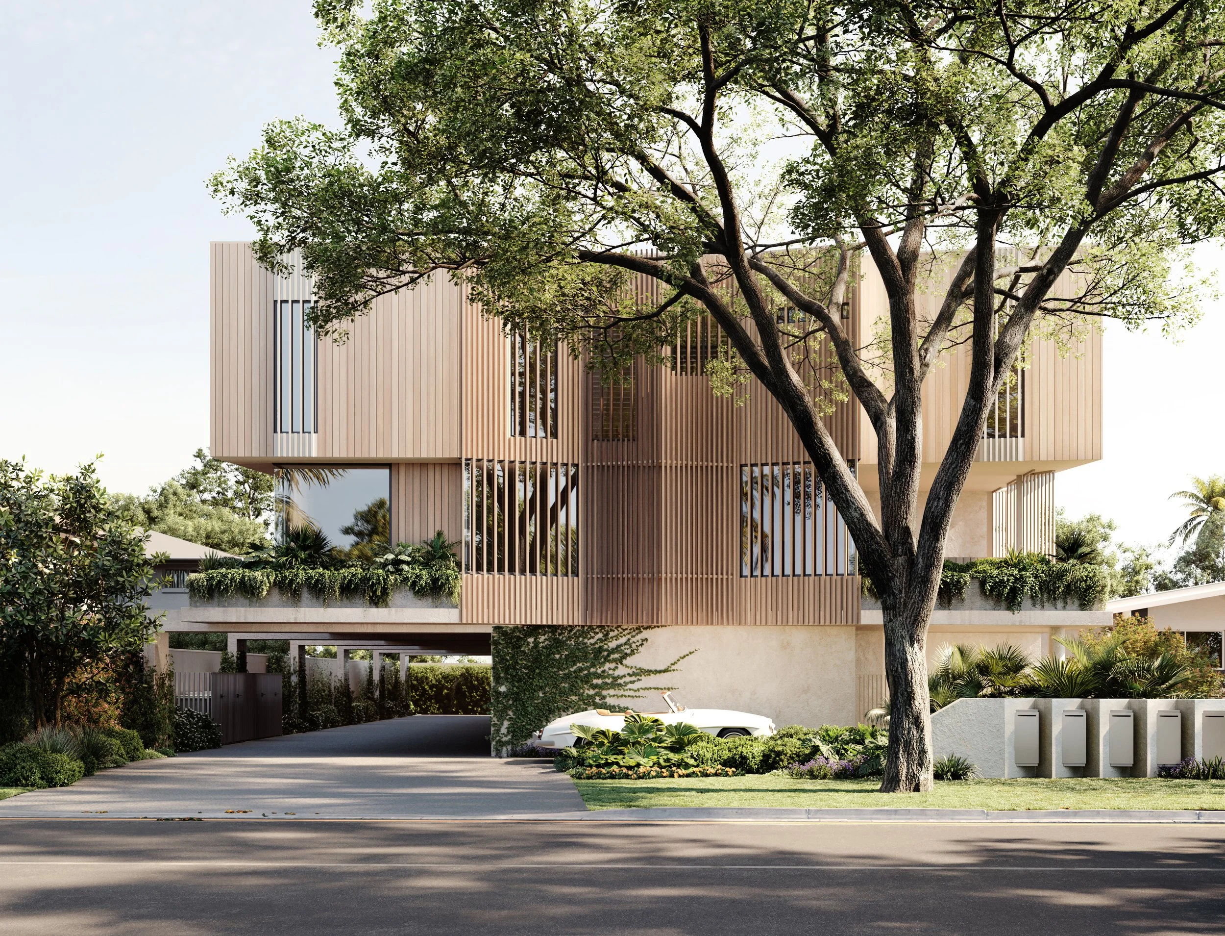 Modern multi-story house with wooden vertical slats, large windows, and greenery, including a tree in the front yard, situated on a tree-lined street.