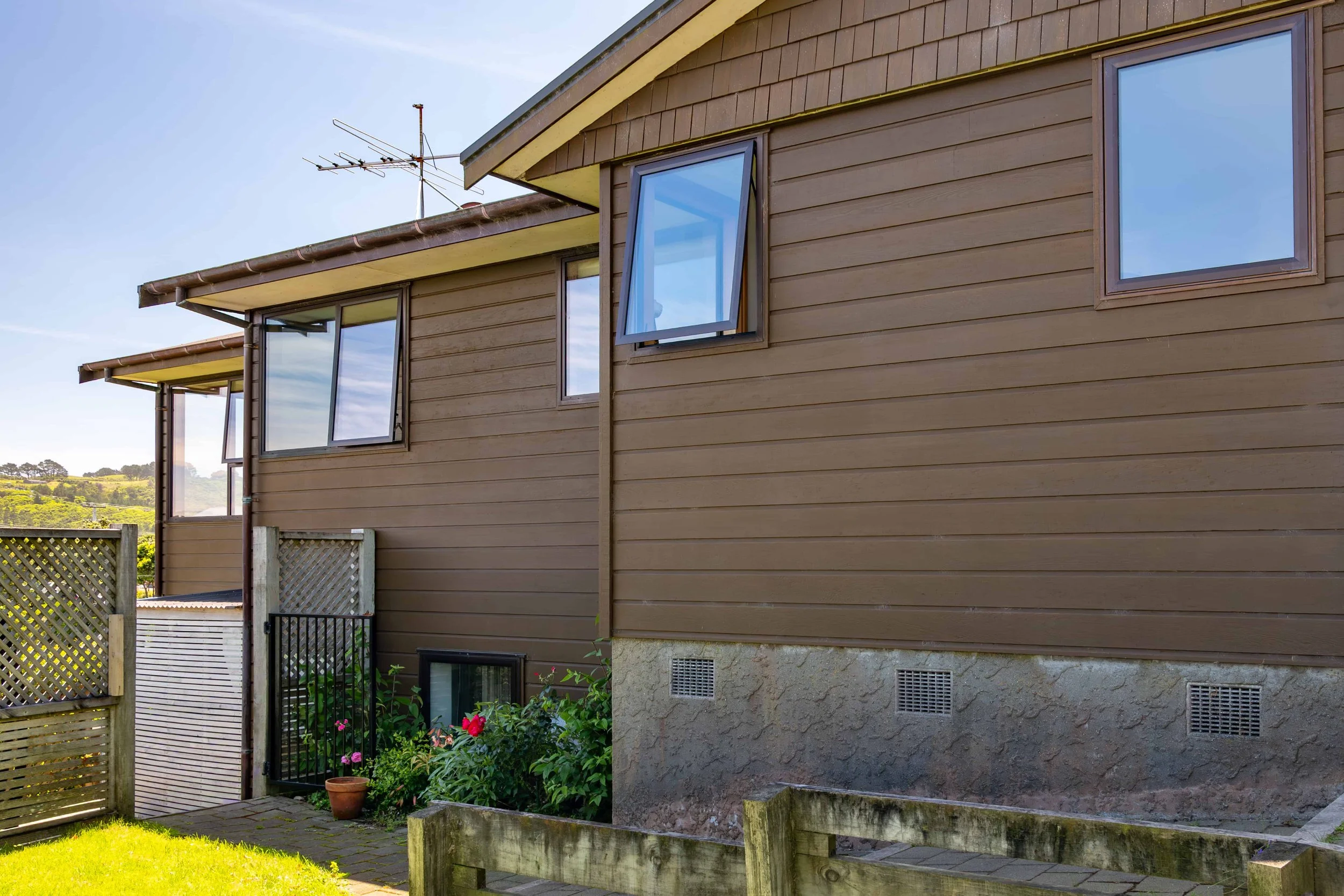 External view of a home with bronze aluminium windows that Eversure has double glazed. reFIT Ali service