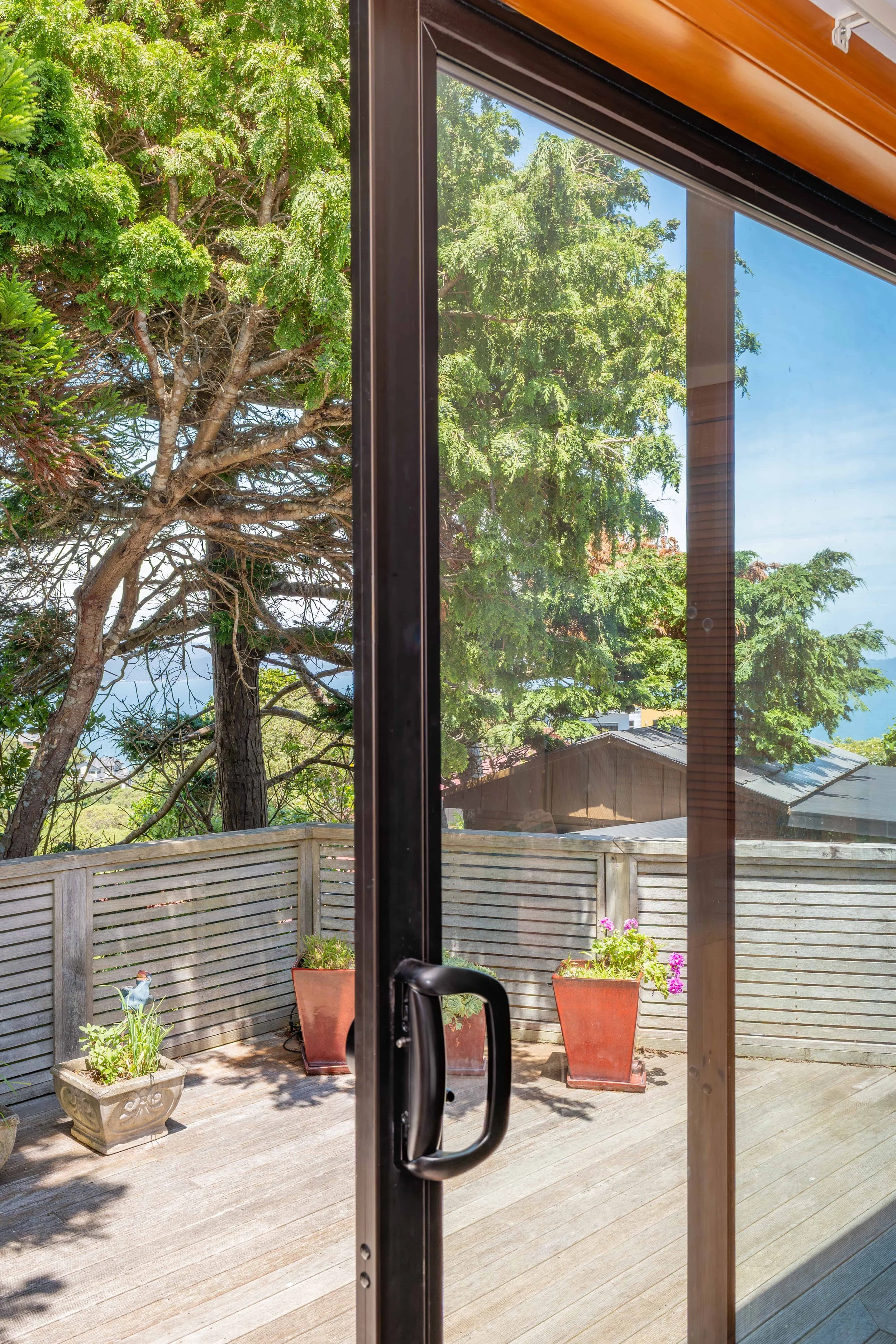 Internal view of a bronze anodised aluminium sliding door that Eversure double glazed. reFIT Ali service
